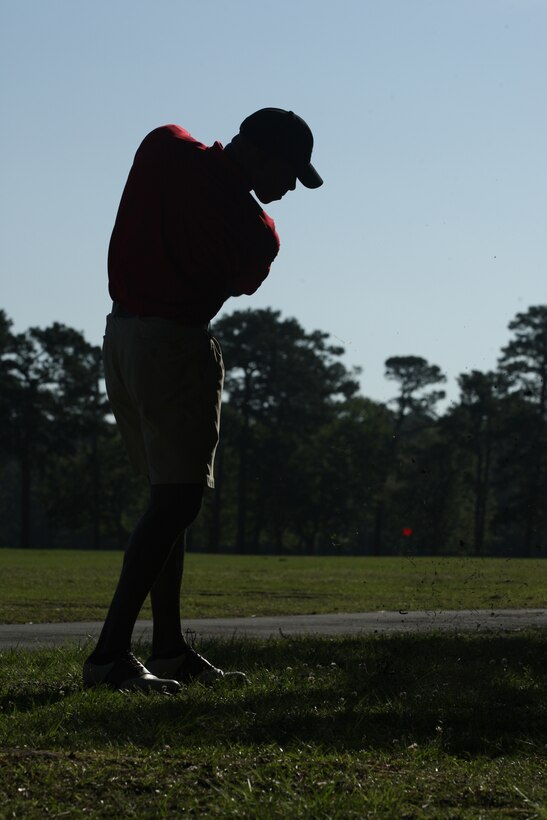 Maj. Damon White, academic officer for the School of Infantry-East, takes his second swing toward the green during intramural golf at the Paradise Point Golf Course, May 20.