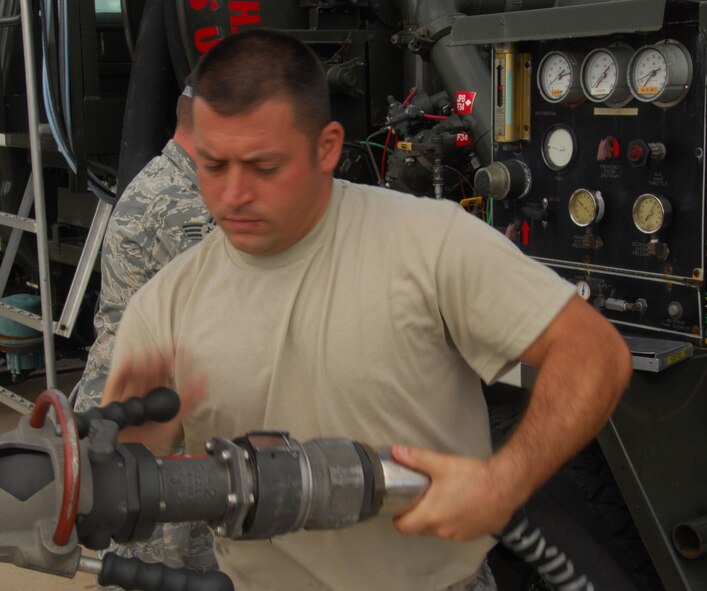 ANDERSEN AIR FORCE BASE, Guam - Tech. Sgt. Dan Rabideau, 36th Logistics Readiness Squadron Petroleum, Oil and Lubricants flight noncommissioned officer in charge of the fuels laboratory, connects a hose from an R-12 refueling truck to a hydrant May 20. These hydrants enable fuel distributors to pump more than the 6,000 gallons an R-11 refueling truck is capable of carrying. (U.S. Air Force photo by Senior Airman Shane Dunaway)
