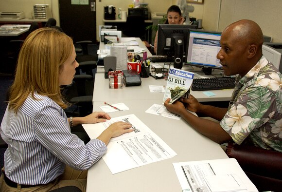 ANDERSEN AIR FORCE BASE, Guam -- Joseph Foster, 36th Force Support Squadron education office advisor, explains the importance and new changes to the Montgomery G.I. Bill to Angela Magana, wife of Master Sgt. Jose Magana, 36th FSS manpower superintendant, at the education office May 19. Recent changes to the bill allows members to transfer the bill to dependants and also has new benefits associated with it. (U.S. Air Force photo by Airman Carissa Wolff)                               