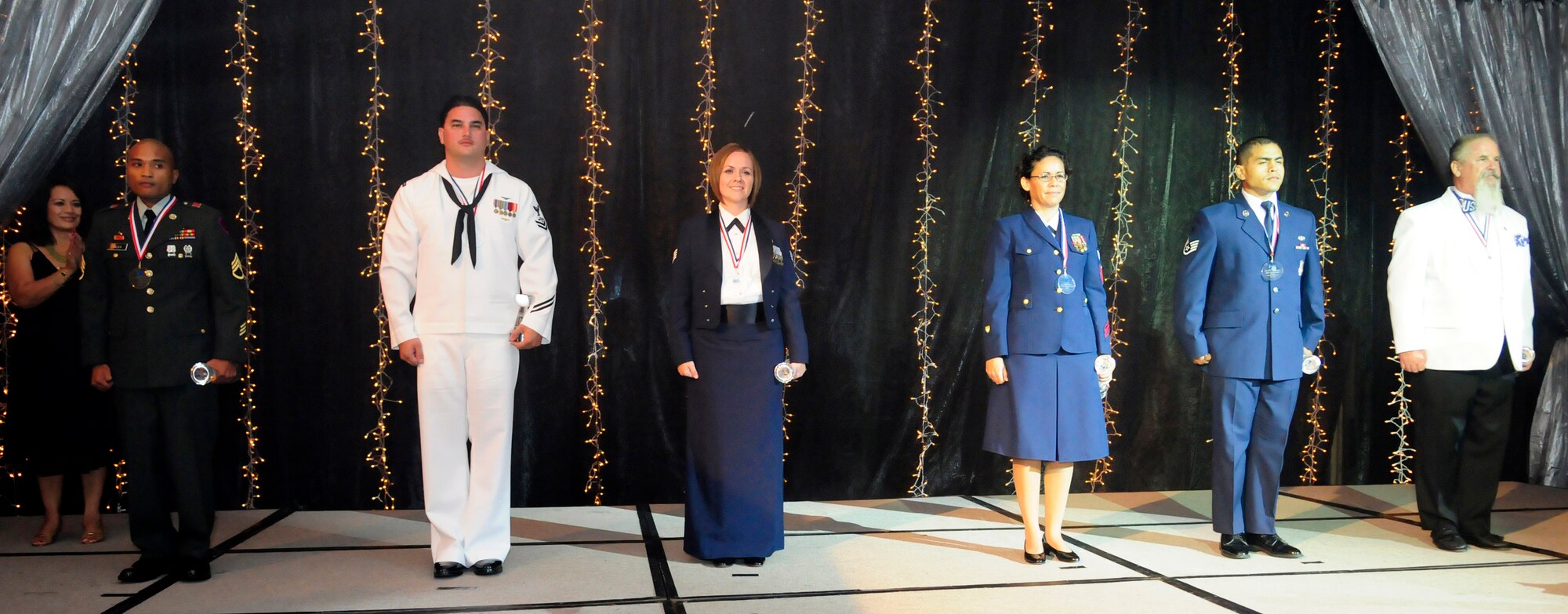 ANDERSEN AIR FORCE BASE, Guam - From left to right, Staff Sgt. Rodel Galila, Aircrew Petty Officer 2nd Class Carlos Carpio, Staff Sgt. Jamie Brewer, Marine Science Technician 1st Class Jennifer Thomas, Staff Sgt. Shuan Morrison. and Rich Ortloff are recognized as USO Servicemembers of the Year Award during the USO Gala at the Hyatt Hotel May 16.(U.S. photo by Airman 1st Class Courtney Witt)

