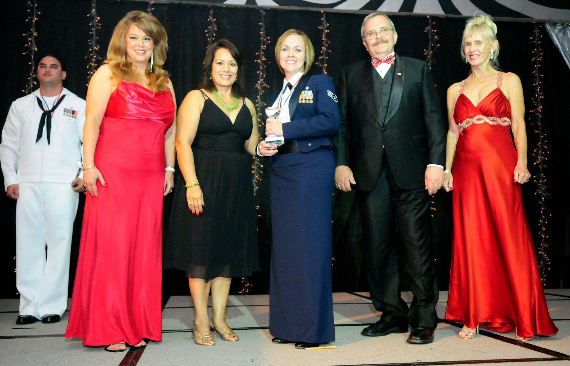 ANDERSEN AIR FORCE BASE, Guam - Staff  Sgt. Jamie Brewer, 36th Medical Support Squadron noncommissioned officer in charge of the TRICARE service center, accepts her USO Service Member of the Year Award from Guam USO Advisory Council Chair Lou Sanchez during the USO Gala at the Hyatt Hotel May 16.  Sergeant Brewer was recognized for her efforts in Iraq as she responded to 2,000 helicopter arrivals and managed 4,000 patient offloads during her deployment. The awards were presented to outstanding military members from each service on Guam during 2008. (U.S. photo by Airman 1st Class Courtney Witt)