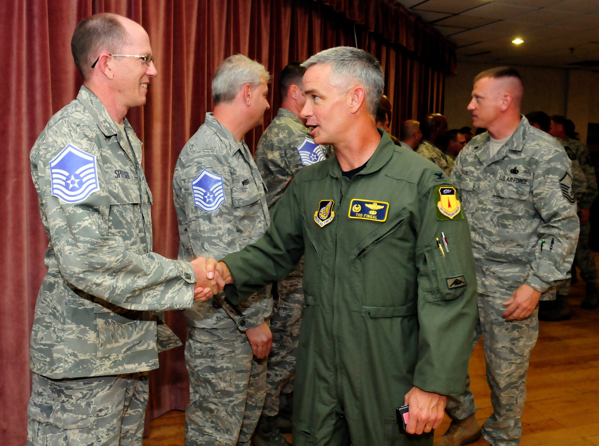 ANDERSEN AIR FORCE BASE, Guam - Col. Tod Fingal, 36th Operations Group commander, congratulates Tech. Sgt. Corey Sprecker, 3rd Aircraft Maintenance Squadron, Elmendorf Air Force Base, Alaska, for his selection to master sergeant during a promotion party at the Top of the Rock here May 15. Forty-nine Andersen technical sergeants were promoted to master sergeant this term. (U.S. Air Force photo by Airman 1st Class Courtney Witt)