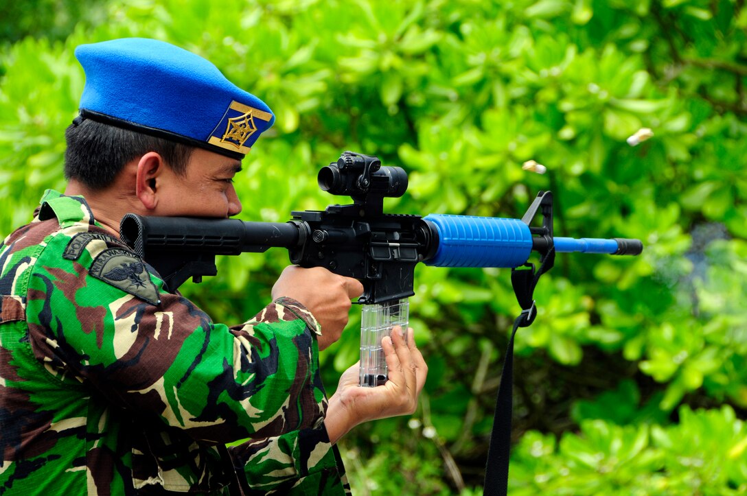 ANDERSEN AIR FORCE BASE, Guam - Indonesia Capt. Tatiet Rozadi shoots a simunition round at Andersen South, May 19. The noise and smoke create a high stress environment during training to simulate real conditions military members face in a combat environment. The purpose of the Subject Matter Expert Exchange visit was to show Andersen's capabilities to the Vietnamese and Indonesian visitors as well as become familiar with nations in the Pacific Command Region. (U.S. Air Force photo by Airman 1st Class Courtney Witt)
