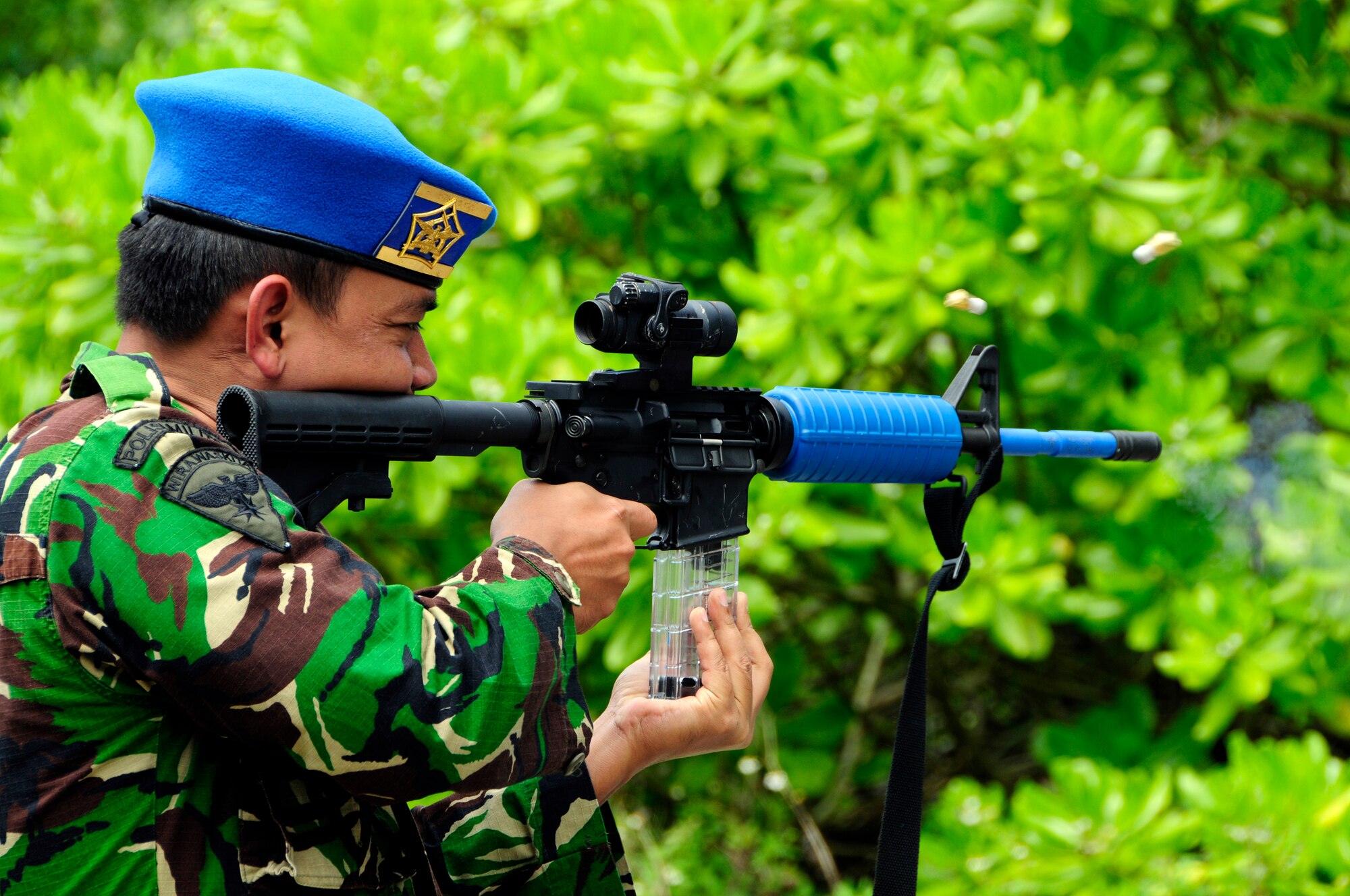 ANDERSEN AIR FORCE BASE, Guam - Indonesia Capt. Tatiet Rozadi shoots a simunition round at Andersen South, May 19. The noise and smoke create a high stress environment during training to simulate real conditions military members face in a combat environment. The purpose of the Subject Matter Expert Exchange visit was to show Andersen's capabilities to the Vietnamese and Indonesian visitors as well as become familiar with nations in the Pacific Command Region. (U.S. Air Force photo by Airman 1st Class Courtney Witt)
