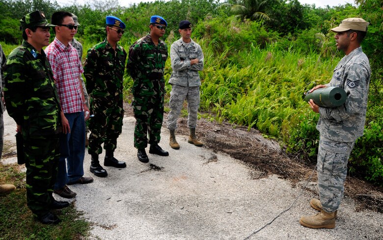 ANDERSEN AIR FORCE BASE, Guam - Staff Sgt. Marcus Serrano, 736th Security Forces Commando Warrior cadre, showcases improvised explosive devices the cadre uses during training exercises to Vietnam Col. Tran Van Thuan and Indonesia Maj. Agung Satya Wibowo and Capt. Tatiet Rozadi at Andersen South, May 19.  Members of the Vietnam and Indonesia military met with Andersen Airmen as part of a Subject Matter Expert Exchange to view Andersen's capabilities and share training initiatives. (U.S. Air Force photo by Airman 1st Class Courtney Witt)
