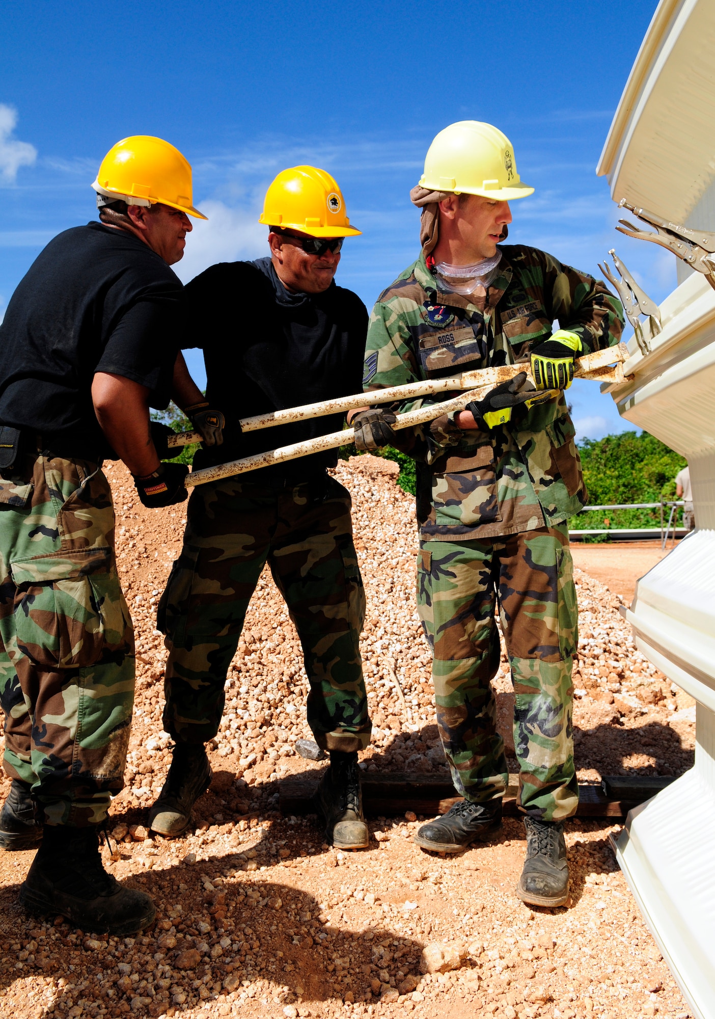 ANDERSEN AIR FORCE BASE, Guam - (From right) Staff Sgt. Joseph Ross, Master Sgt. Arthur Galindo, and Staff Sgt. Jose Jimenez-Garcia, 144th Air National Guard Civil Engineer Squadron, clamp two arcs together before seaming at Northwest Field May 13. The 144th ANG CES are here for two weeks to help with the k-span building that will continue till August 1. (U.S. Air Force photo by Airman 1st Class Courtney Witt)
