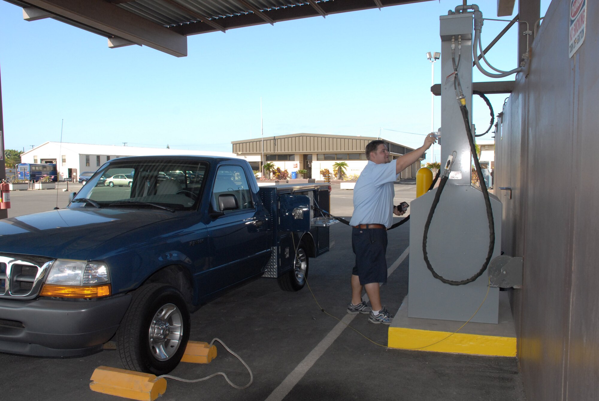 Matt Morse demonstrates the use of the hydrogen station at Hickam Air Force Base, Hawaii, May 13 on a one-of-a-kind, custom-built electric flightline maintenance support vehicle. The state of Hawaii formed a partnership with the Air Force and established the National Demonstration Center for Alternative Fuel Vehicles in 2001. Early projects included both hybrid and all-electric vehicles, to include the electric shuttle bus operating at the passenger terminal. More recently, a lithium battery-powered step van was developed and demonstrated and will soon go commercial. Mr. Morse is a project engineer. (U.S. Air Force photo/Senior Airman Carolyn Viss)