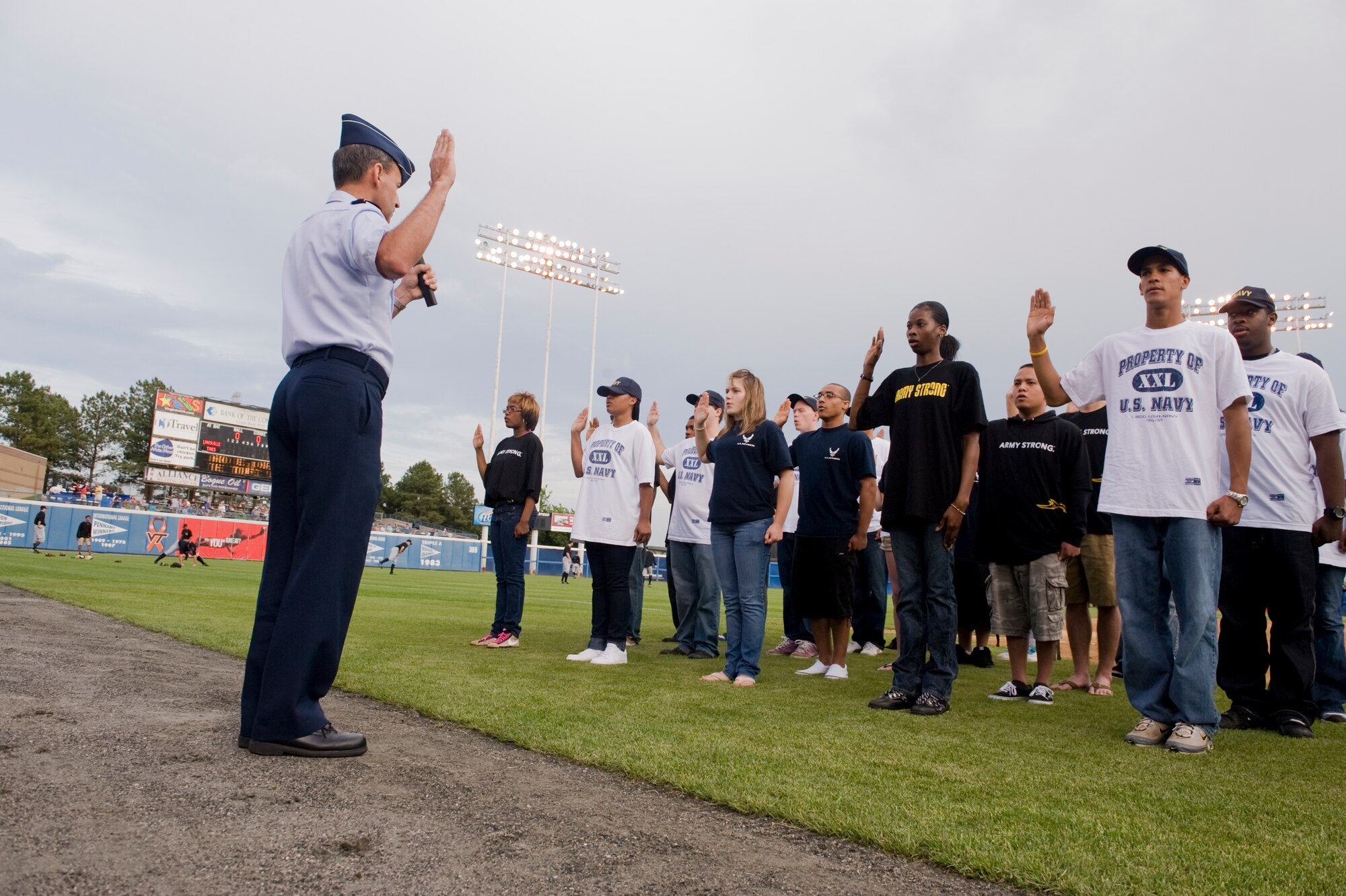 NORFOLK, Va -- Air Force Maj. Gen. David Edgington, the U.S. Joint Forces Command's chief of staff, enlists 40 local recruits during the opening ceremony of the Norfolk Tides baseball club's 14th annual Military Appreciation Night at Harbor Park May 16. (DOD photo/Staff Sgt. Joe Laws)