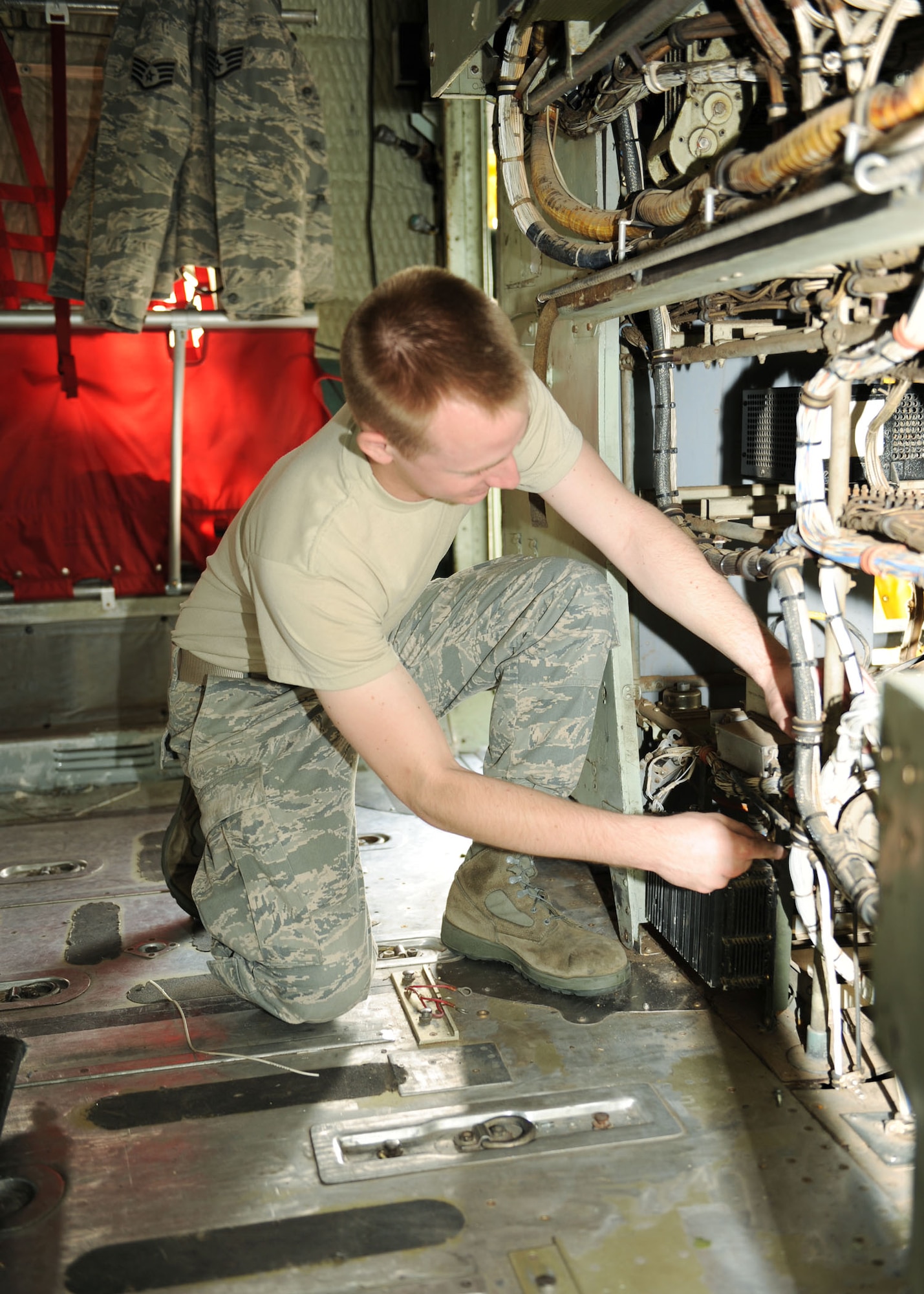 SCOTT AIR FORCE BASE, Ill. -- Airman 1st Class Jeff Wilson, 19th Maintenance Squadron communications navigator at Little Rock Air Force Base, Ark., helps remove hazardous material and equipment from a C130-E.  The items removed from the plane can be reused at a later time. The aircraft is being prepared for the Scott Field Heritage Airpark. (U.S. Air Force photo/Airman 1st Class Tristin English)