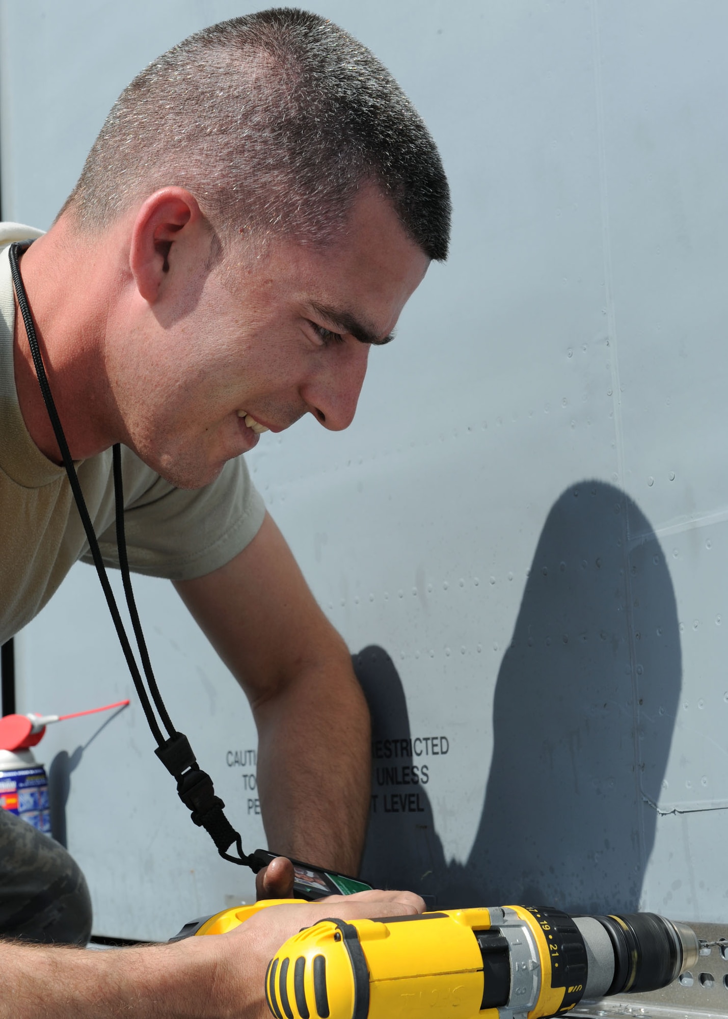 SCOTT AIR FORCE BASE, Ill. -- Staff Sgt. Christopher Kaker, 19th Maintenance Squadron, crew chief, drills metal into the tail of the plane to make sure it stays intact before it’s placed in the airpark. (U.S. Air Force photo/Airman 1st Class Tristin English)