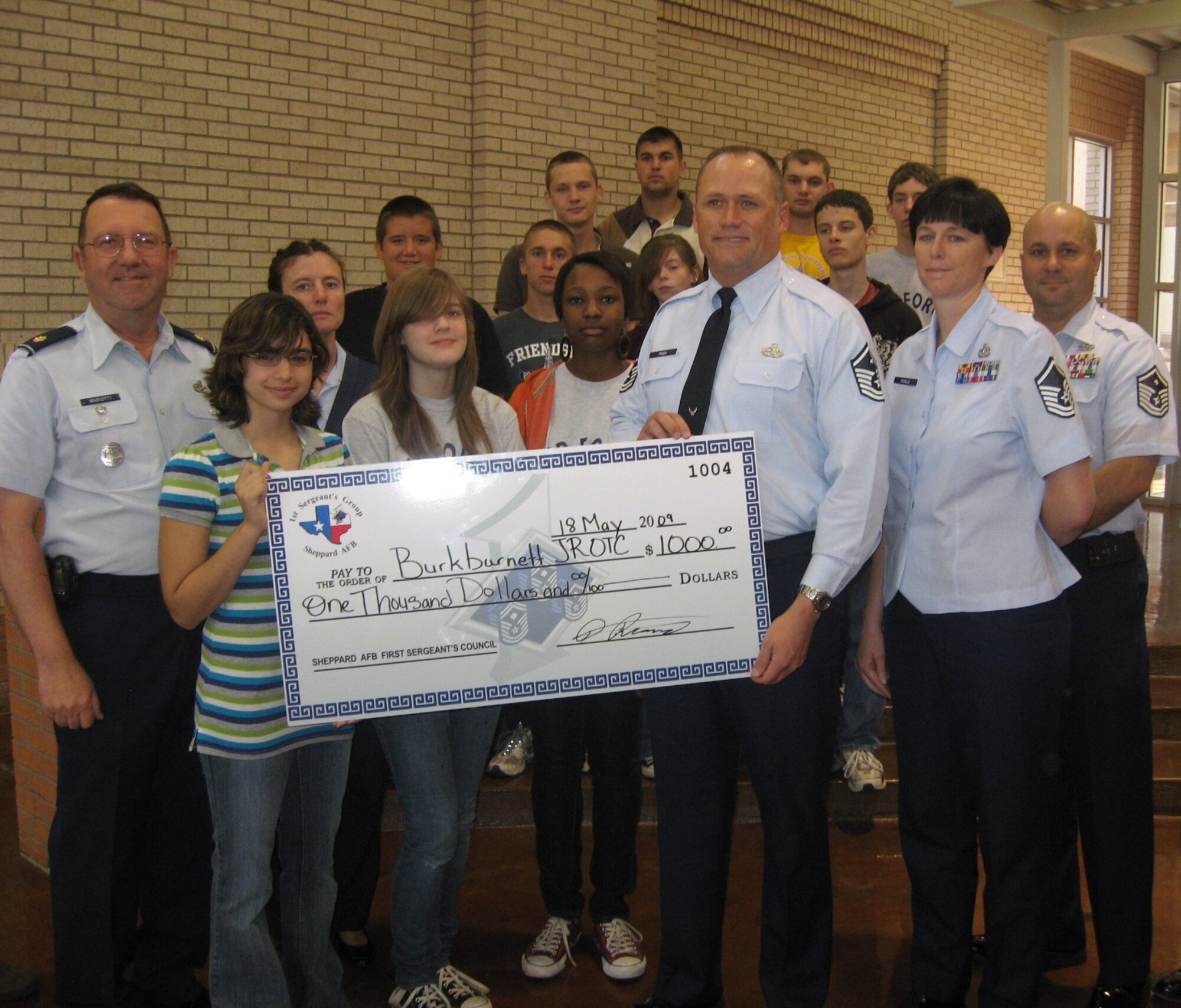 The Sheppard First Sergeant’s Council presented a $1,000 check to the members of Burkburnett High School Junior Reserve Officers’ Training Corps May 18 at the high school.(U.S. Air Force photo/Debi Smith)