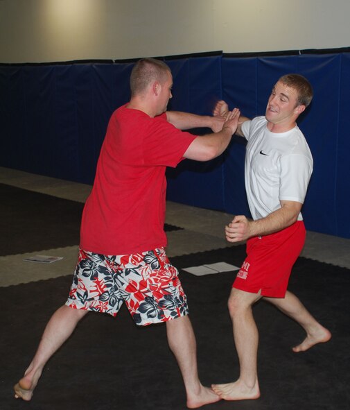 Second Lt. Tom Cunningham throws a punch and Tech Sgt. Michael Mansker demonstrates how to block it during the instructor’s course for the Targeted Intervention self defense class. The class teaches male Airmen how to intercede to prevent sexual assaults from happening. (U.S. Air Force photo/ Airman 1st Class Matthew Varga)