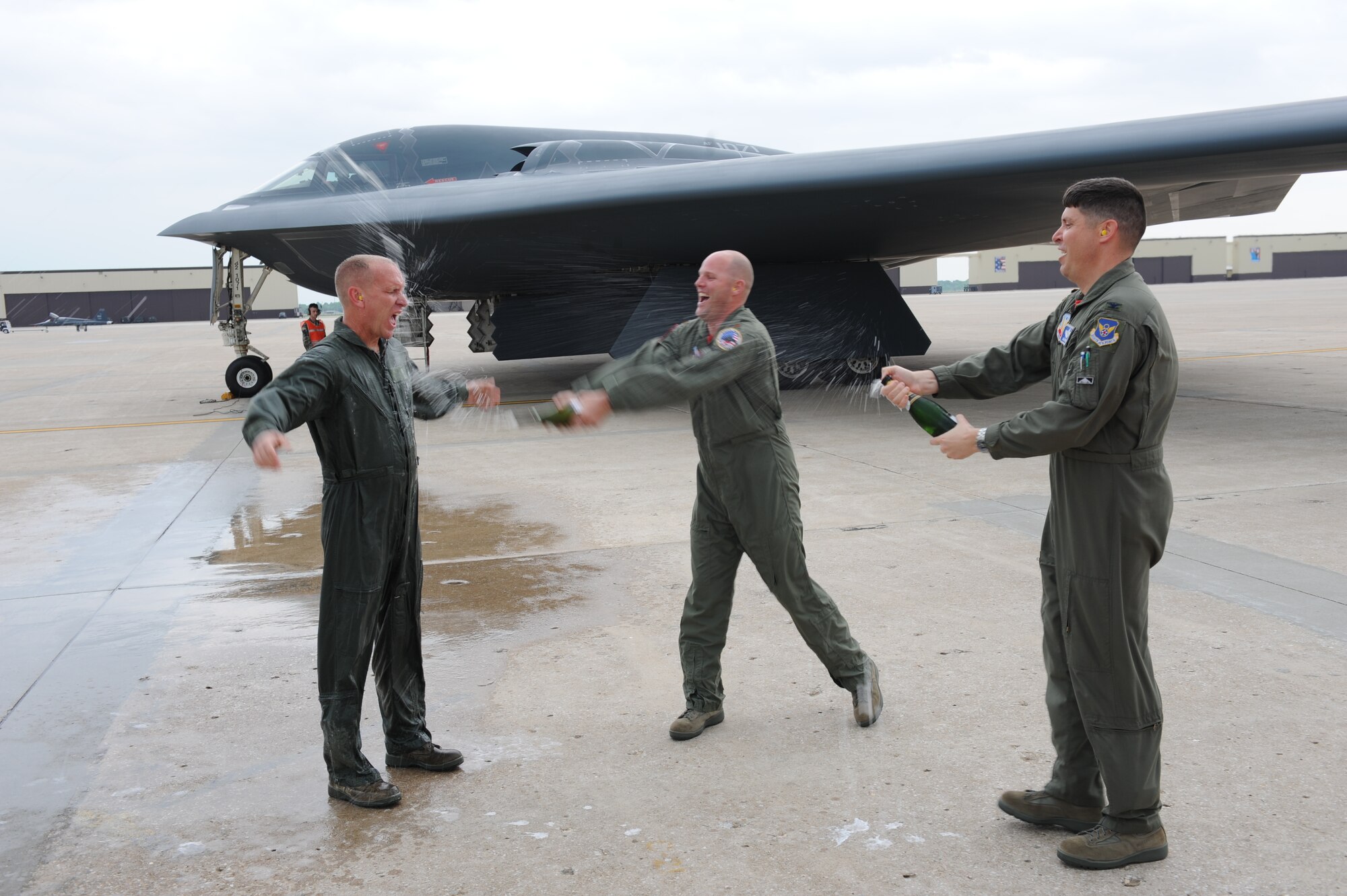 WHITEMAN AIR FORCE BASE, Mo. - Col. John Robinson (right), 509th Bomb Wing vice commander, and Maj. Bob Bryant(center), 509th Bomb Wing executive officer, spray Chief Master Sgt. Brian Hornback, 509th Bomb Wing command chief, with champagne after his first and last flight in a B-2 bomber May 15. (U.S. Air Force photo/Tech. Sgt. Charles Larkin)