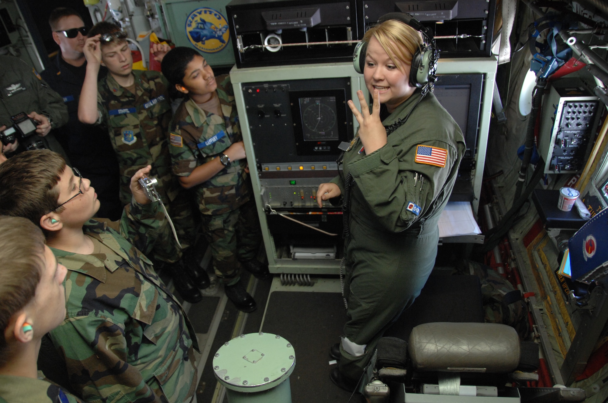 KEESLER AIR FORCE BASE, Miss.-Senior Airman Jenna Daniel, loadmaster with the 53rd Weather Reconnaissance Squadron Keesler AFB, Miss. explains to a group of civil air patrollers how the Hurricane Hunters launch a dropsonde . The dropsonde is the tool Hurricane Hunters use to gather weather data when flying through storms. The group of civil air patrollers joined the Hurricane Hunters on a training mission May 20. (U.S. Air Force Photo by 2nd Lt. Joe Simms)