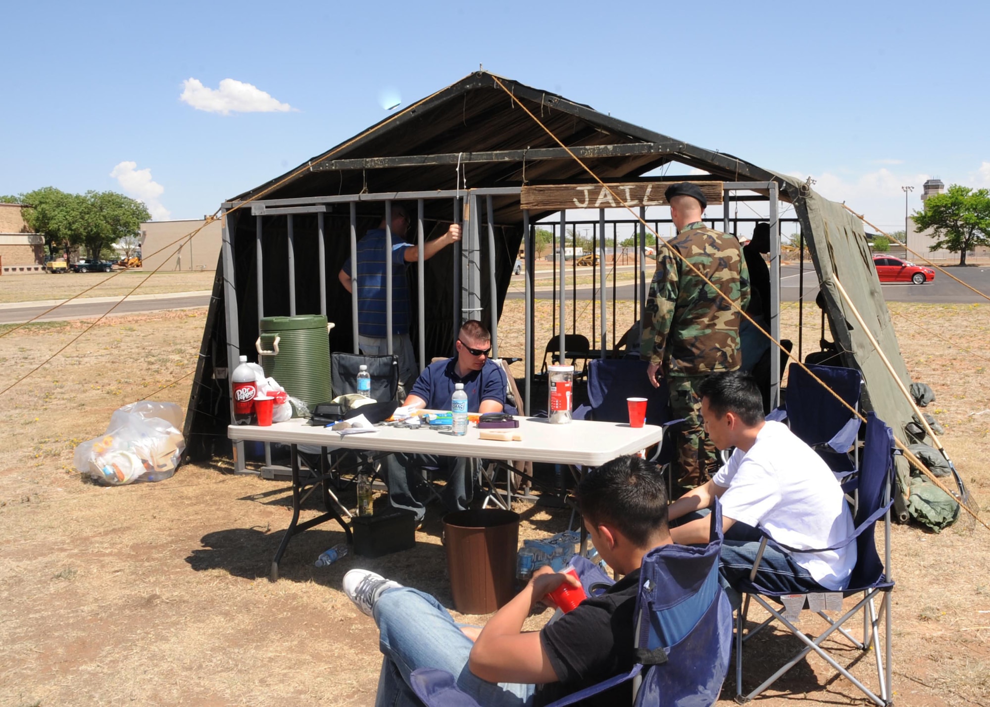 CANNON AIR FORCE BASE, N.M. -- "Prisoners" are held by off-duty security personnel during the annual Jail and Bail event here May 12. A portion of the money collected at this event goes to local police charities. (U.S. Air Force photo/Airman 1st Class Maynelinne De La Cruz)