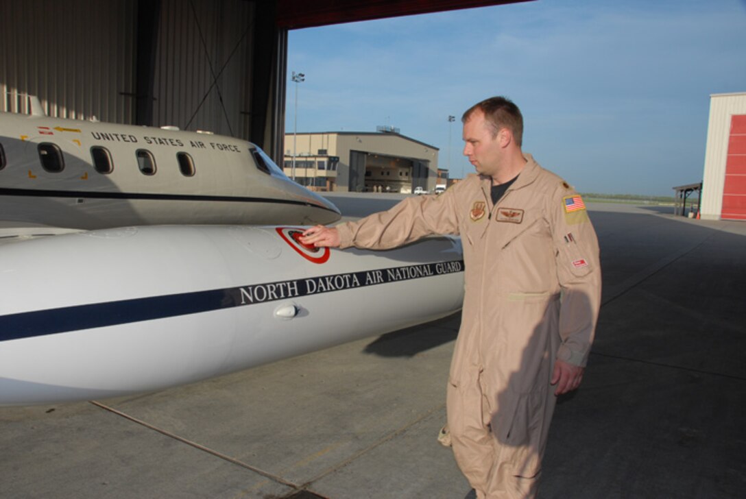 Maj. Jason Newham, of the 177th Airlift Squadron, North Dakota Air National Guard does a pre-flight inspection of a C-21 at the North Dakota Air National Guard May 20, Fargo, N.D.  This is the first time that the North Dakota Air National Guard C-21s have deployed to southwest Asia in support of Operation Enduring Freedom.  The Airmen will be supporting the mission in alternating shifts throughout the summer.  The 119th Wing began flying the C-21 Lear Jets after the unit lost their F-16 Fighting Falcons in January 2007.  (DoD photo by Senior Master Sgt. David H. Lipp) (Released)
