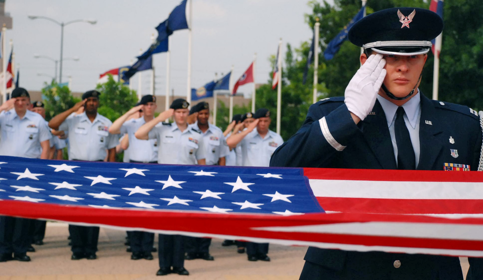 LAUGHLIN AIR FORCE BASE, Texas – Capt. Bruce Auville, Laughlin Honor Guard, pays respects to the American Flag as members of the 47th Security Forces Squadron follow his lead during a formal retreat held in honor of National Peace Officers Memorial Day here May 15. National Peace Officers Day and Police Week are 46-year traditions honoring actively serving and fallen peace officers.  Along with honoring the defenders, this week also gives Laughlin members an opportunity to learn about security forces and the jobs they do daily through events held during the week including sporting events, demonstrations and static displays. (U.S. Air Force photo by Airman 1st Class Sara Csurilla)
