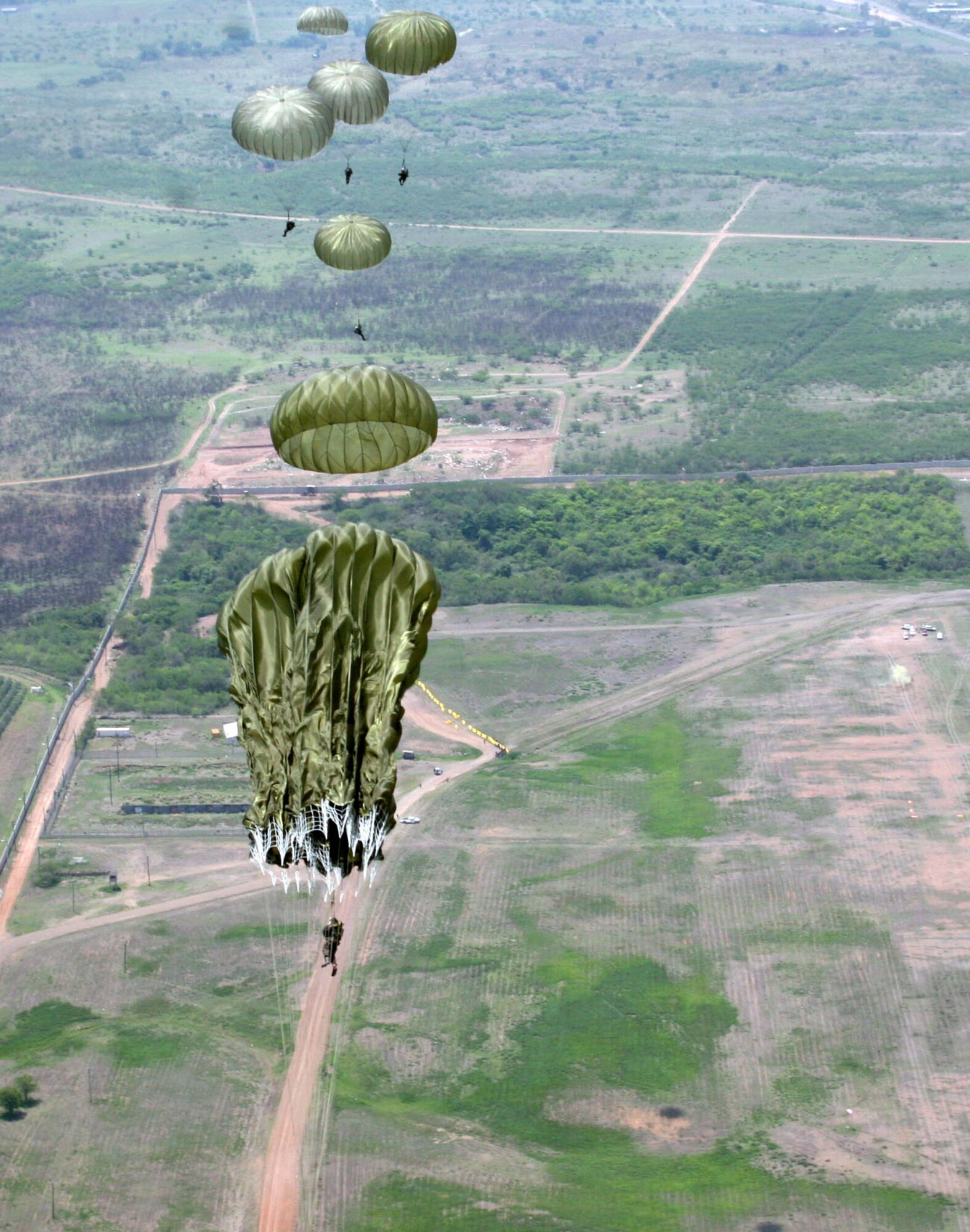 Honduran "paracaidistas" -- paratroopers -- jump from the back of a U.S. Air Force HC-130 May 16 over Soto Cano AB, Honduras. Nearly 200 U.S. Army and Honduran jumpers, along with 10 U.S. Air Force aircrew members, participated in the combined training. (Courtesy photo)