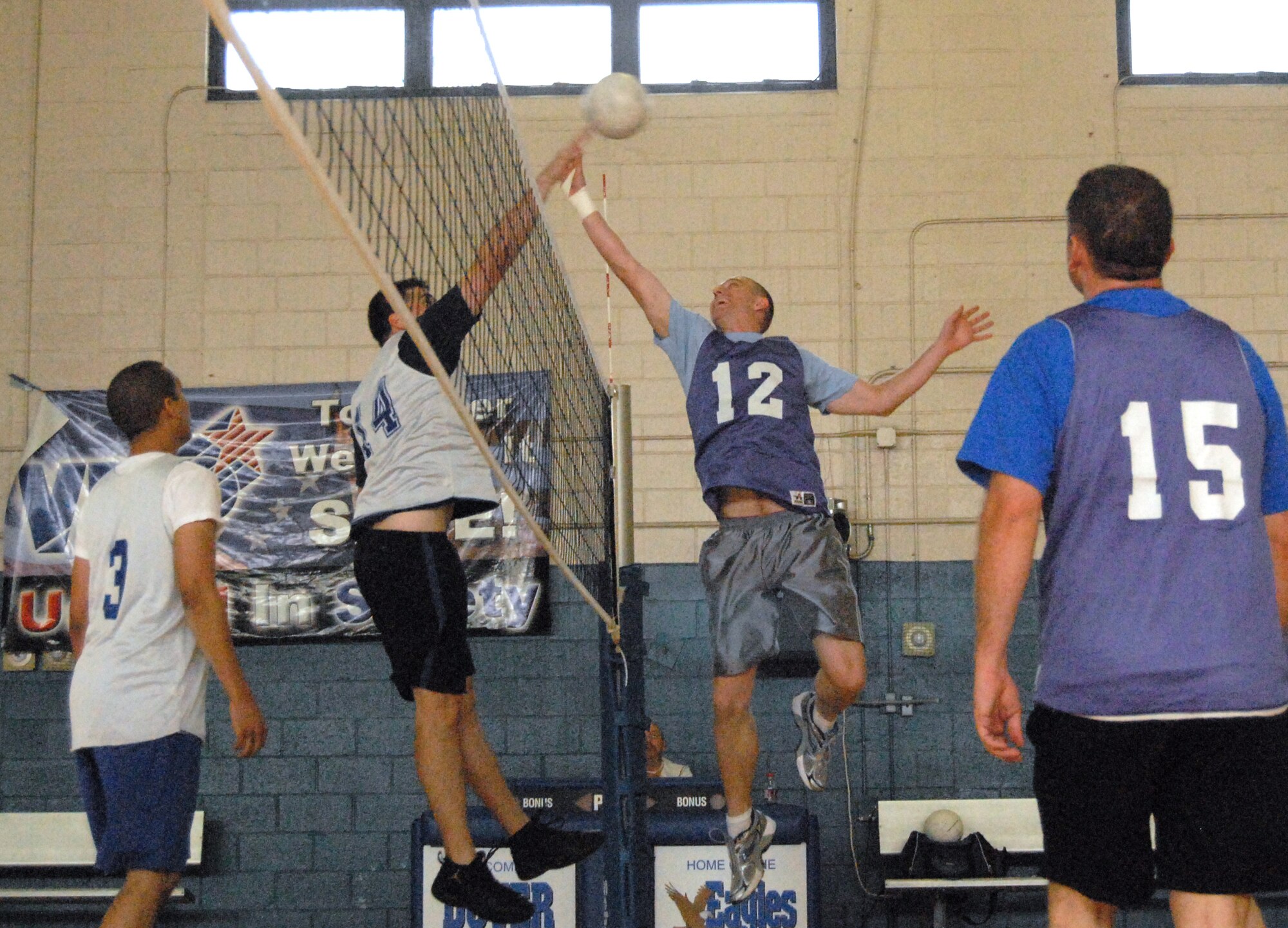 (Left to right) Daniel Johns, 436th Communications Squadron, fights to spike the ball as Stephen Hart, 436th Maintenance Operations Squadron, tries to defend the net with a block. (U.S. Air Force photo/ Airman 1st Class Shen-Chia Chu) 