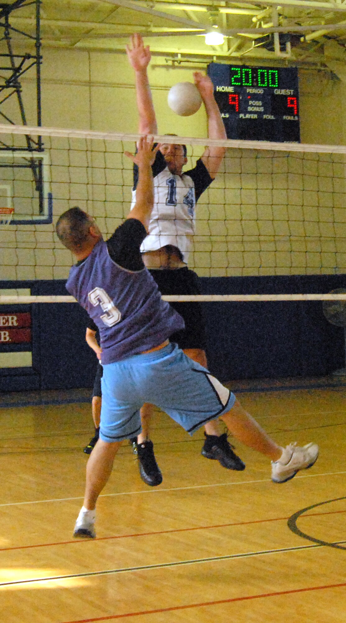 (Front to back) Salvatore Corrao, 436th Maintenance Operations Squadron, spikes the ball as Daniel Johns, 436th Communications Squadron, leaps for the block. Corrao?s spike made a scoring point for the team. (U.S. Air Force photo/ Airman 1st Class Shen-Chia Chu) 
