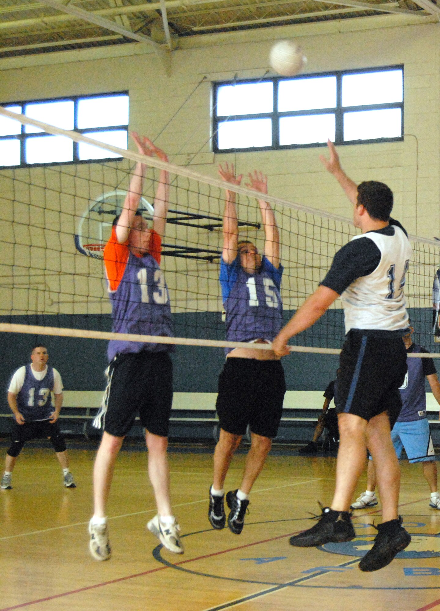 (Right to Left) Daniel Johns, 436th Communications Squadron, spikes the ball as 436th Maintenance Operations Squadron players, Christopher Smith and David Weaver, block the ball during a match  (U.S. Air Force photo/ Airman 1st Class Shen-Chia Chu) 