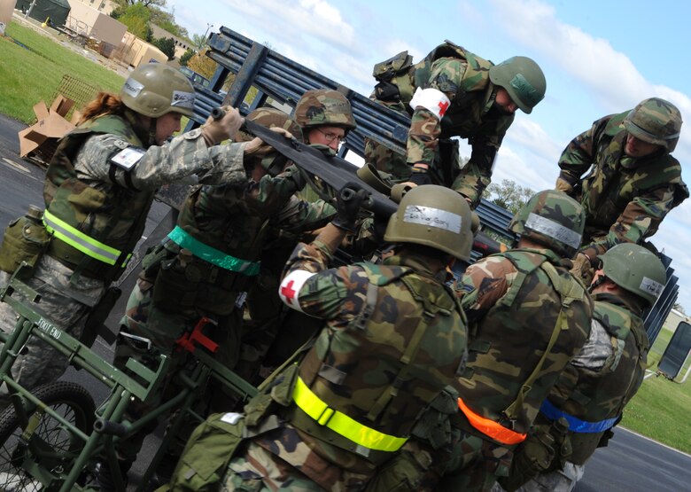 VOLK FIELD, Wisc. -- Medical professionals from the 375th and 133rd Airlift Wings practice lifting stretchers onto vehicles for transport to an aeromedical evacuation aircraft during an operational readiness exercise at Volk Field, Wisc., May 16. Airmen from active duty, Air National Guard and Reserve forces teamed up to participate in the week-long training exercise in preparation for their operational readiness inspection in March 2010.  (U.S. Air Force photo/Airman 1st Class Wesley Farnsworth)