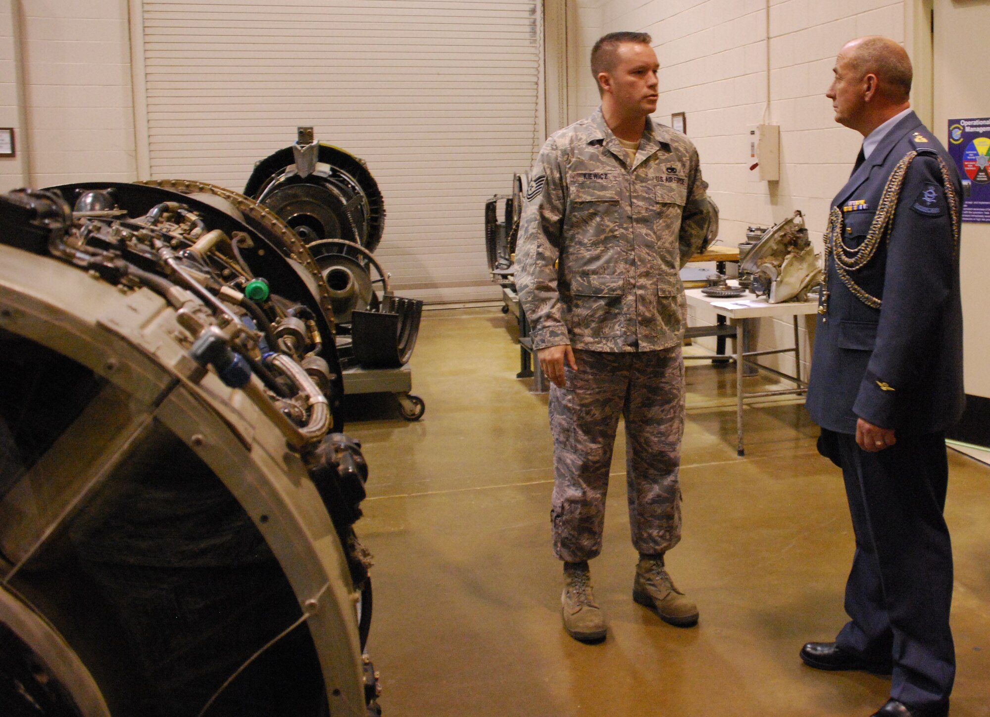 Tech. Sgt. Aaron Kiewicz explains the training process and tools the Airmen use as they develop the skills they need to lead well and serve better at their next duty station to Chief Warrant Officer of the Royal Netherlands air force Andre van Hugent May 19. (U.S. Air Force photo/Airman Adawn Kelsey)