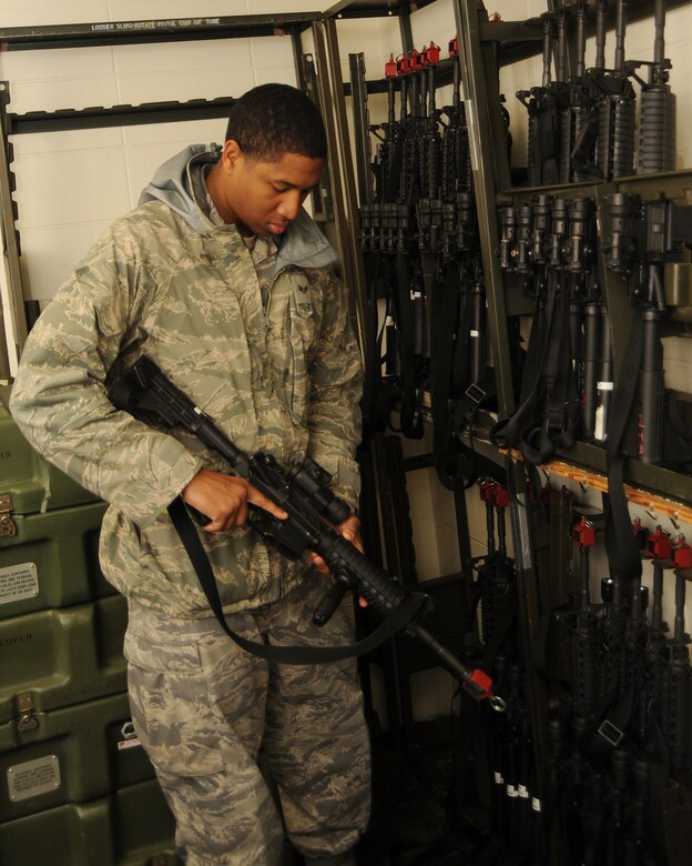 VOLK FIELD, Wisc. -- Senior Airman Chris Smith, 375th Logistics Readiness Squadron mobile armorer, inspects weapons at Volk Field, Wisc., prior to signing them out to the selectively-armed augmentation force participating in the operational readiness exercise at Volk Field, Wisc., May 15. For the exercise, Airmen from active duty, Air National Guard and Reserve teamed up to practice their wartime readiness skills in anticipation of their joint inspection in March 2010.  (U.S. Air Force photo/Airman 1st Class Wesley Farnsworth)