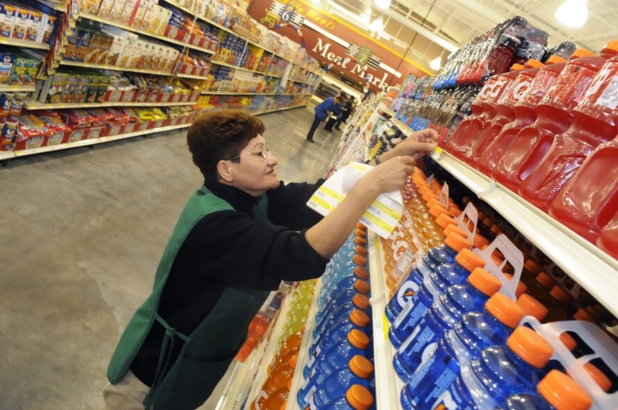 Amalia (Margie) Beaver changes item tags on store merchandise in preparation for the grand opening of the commissary May 28. U. S. Air Force photo by Sue Sapp