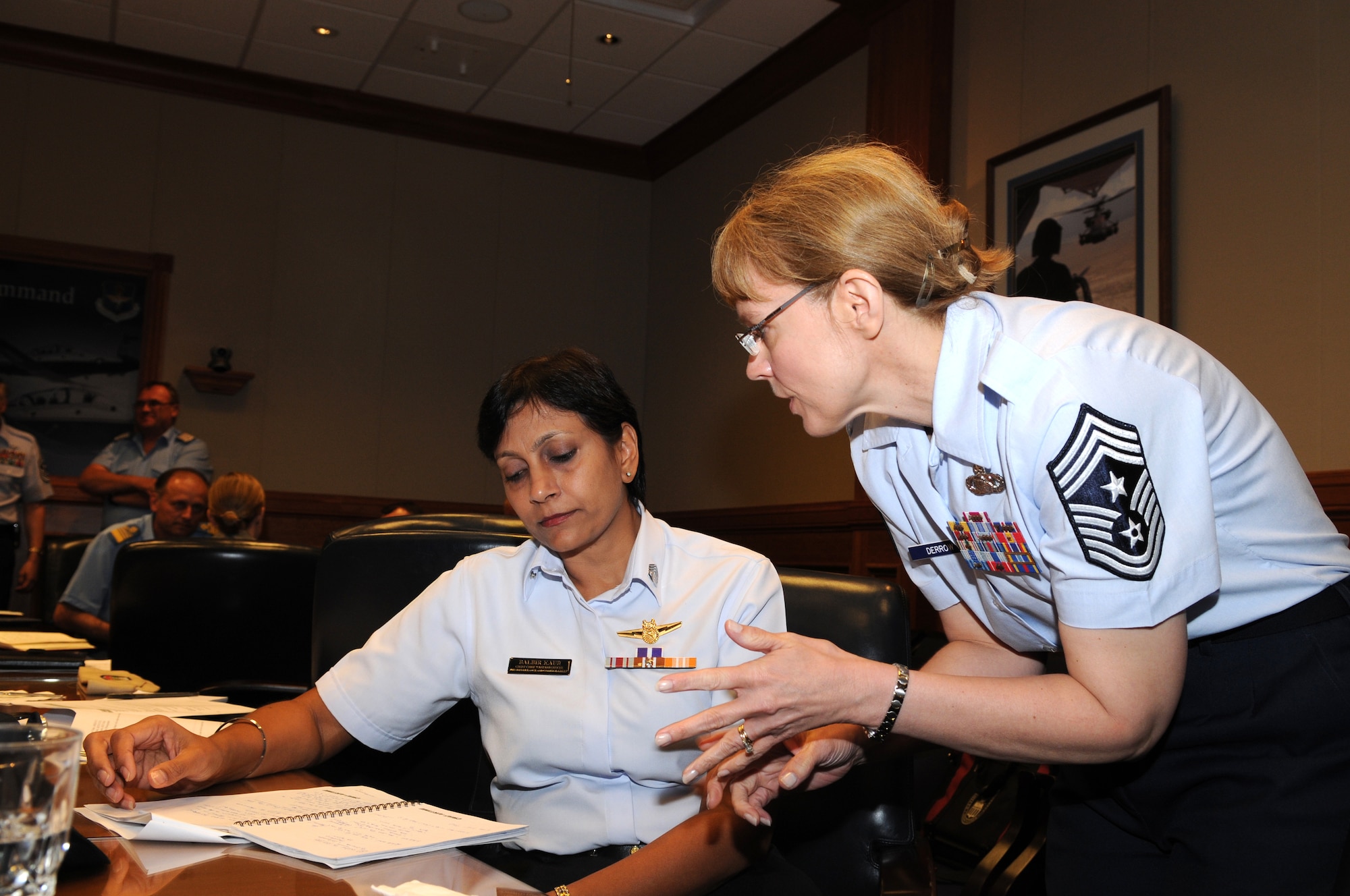 Chief Master Sgt. Pamela Derrow (right), United States Air Forces in Europe command chief, talks with Singapore air force Warrant Officer Balbir Kaur during the 2009 Worldwide Senior Enlisted Leaders visit May 12-15 at Randolph Air Force Base, Texas. The visit was hosted by U.S. Air Force senior enlisted leaders to give their foreign counterparts a look at a U.S. Air Force enlisted member's career from start to finish. (U.S. Air Force photo by Rich McFadden)