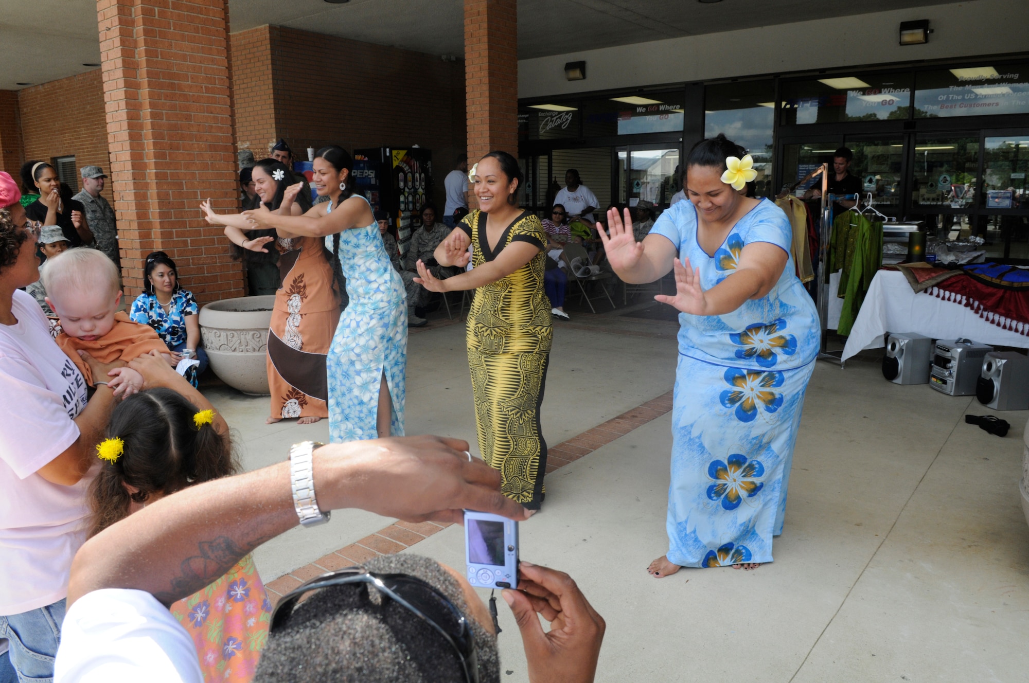 1st Lt. Jennifer Fillmore, SrA Maryann Goings, SrA Chrissina Tavake and Maryell Tyrell perform a Samoan Polynesian Dance in traditional costumes. U. S. Air Force photo by Sue Sapp