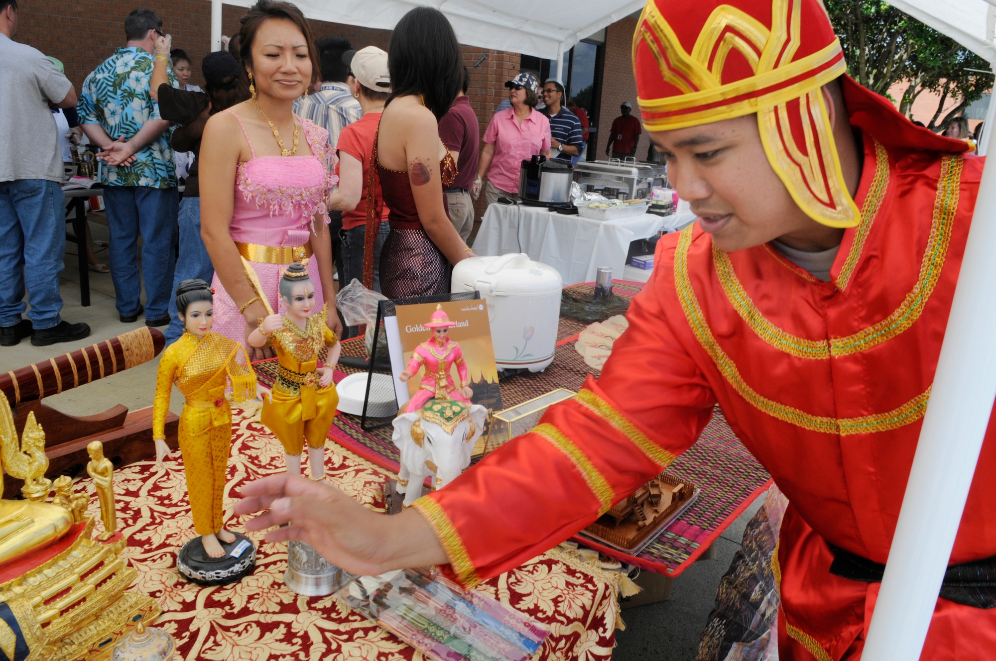 SSgt. Alex Moommala, 78th Medical Group, sets up a display representing Thailand at the  Asian Pacific American Heritage Cultural Fair at Robins May 15. He is wearing a traditional soldier outfit.U. S. Air Force photo by Sue Sapp