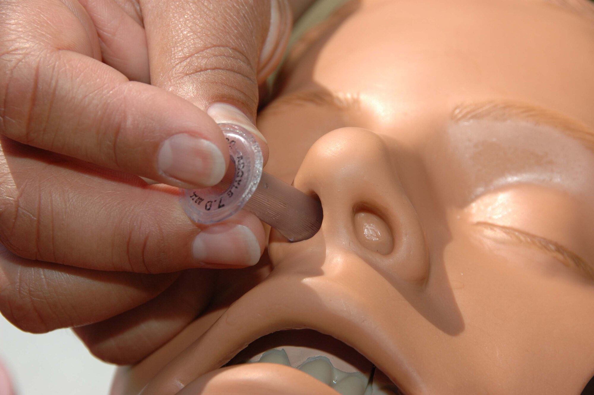 MCGUIRE AIR FORCE BASE, N.J. -- Maj. Michelle Dunkley, a flight nurse with the 514th Aeromedical Staging Squadron, demonstrates proper insertion of a nasopharyngeal airway device. In April select 514th Air Moiblity Wing members took self-aid buddy care training in preparation for the wing's June Operational Readiness Inspection.  (U.S. Air Force photo/Staff Sgt. Monica Dalberg)