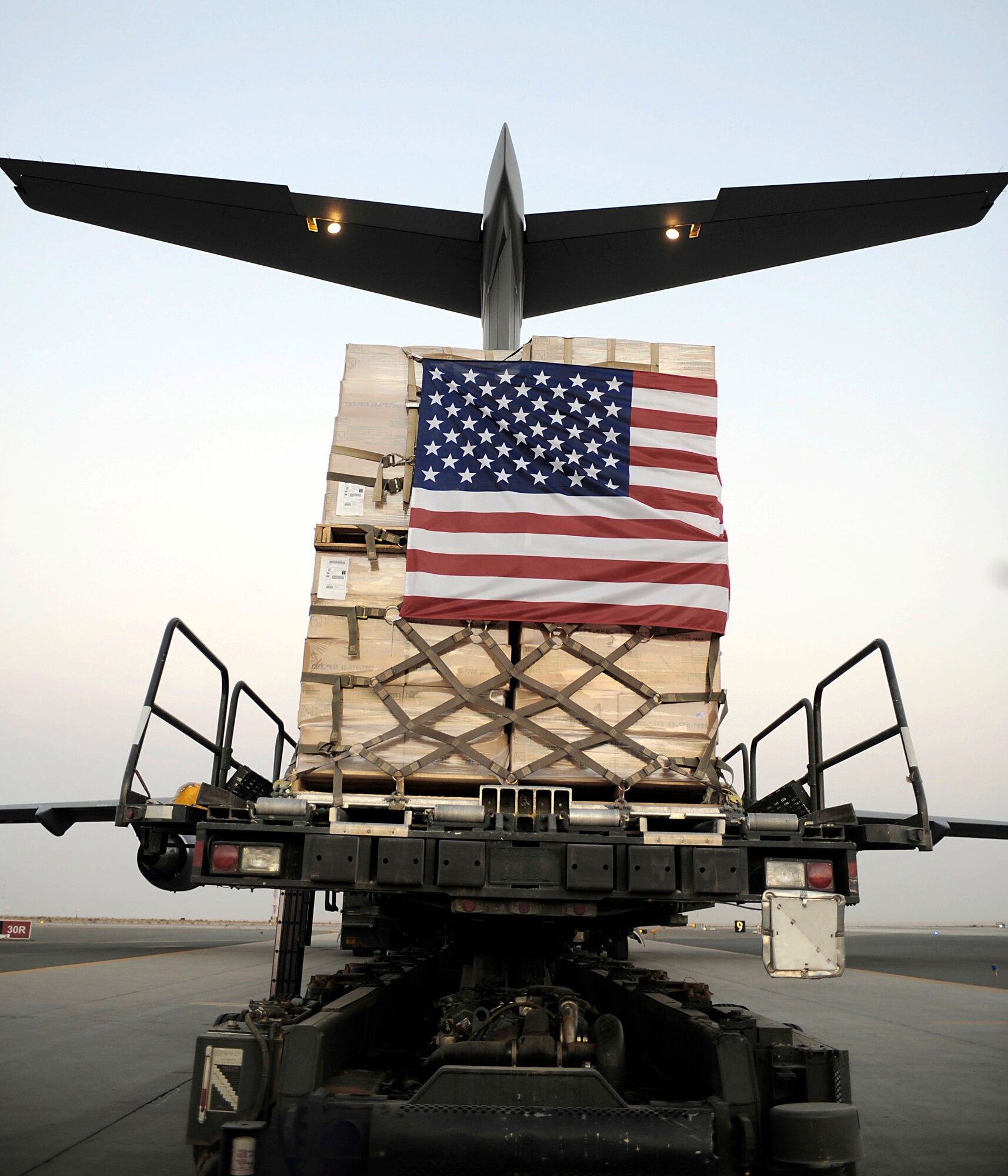 A pallet containing humanitarian relief supplies destined for Pakistan is prepared to be loaded into the cargo bay of a C-17 Globemaster III May 20 at an air base in Southwest Asia. (U.S. Air Force photo/Staff Sgt. Shawn Weismiller)