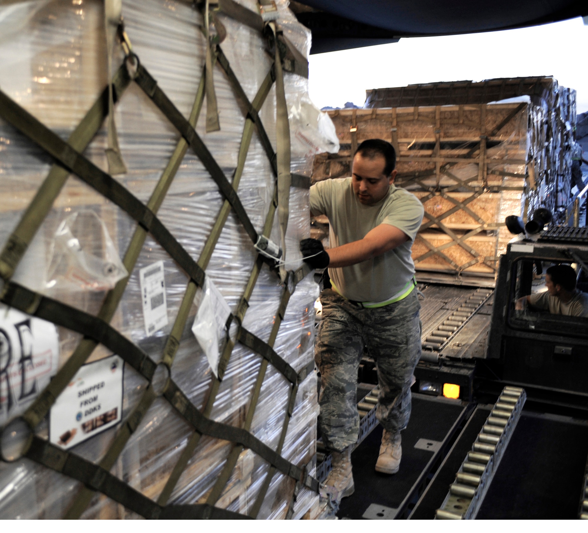 Master Sgt. Thomas J. Kondziella loads a pallet containing humanitarian relief supplies destined for Pakistan into the cargo bay of a C-17 Globemaster III May 20 at an air base in Southwest Asia. (U.S. Air Force photo/Staff Sgt. Shawn Weismiller)
