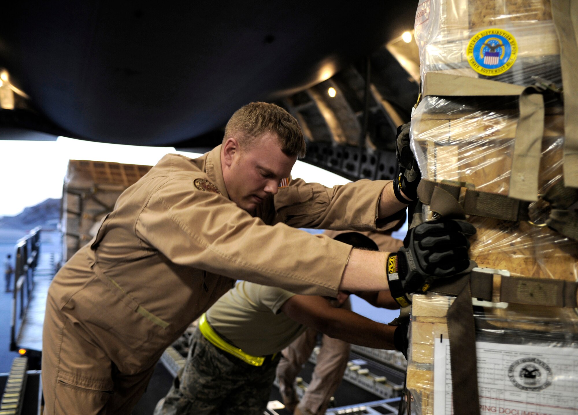 Tech. Sgt. Matt Pease loads a pallet containing humanitarian relief supplies destined for Pakistan into the cargo bay of a C-17 Globemaster III May 20 at an undisclosed location in Southwest Asia. Sergeant Pease is a Raven assigned to the 816th Expeditionary Airlift Squadron. (U.S. Air Force photo/Staff Sgt. Shawn Weismiller)