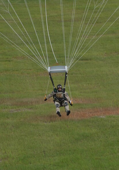 MOODY AIR FORCE BASE, Ga. -- A Pararescueman from the 38th Rescue Squadron lands near the position of a simulated downed pilot who has gone down behind enemy lines during a demonstration held for the Moody Spouses Appreciation Day here May 15. Participants had the opportunity to see a part of Moody’s mission and what happens during some real world events. (U.S. Air Force Photo by Staff Sgt. Javier Cruz Jr.)