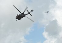 MOODY AIR FORCE BASE, Ga. -- An HH-60G Pave Hawk helicopter from the 41st Rescue Squadron along with an A-10C Thunderbolt II aircraft from the 75th Fighter Squadron patrol the airspace above where a simulated downed pilot is located during a live fire and rescue demonstration during the Moody Spouses Appreciation Day here May 15. Participants were able to view a simulated real world rescue during the demonstration. (U.S. Air Force Photo by Staff Sgt. Javier Cruz Jr.)