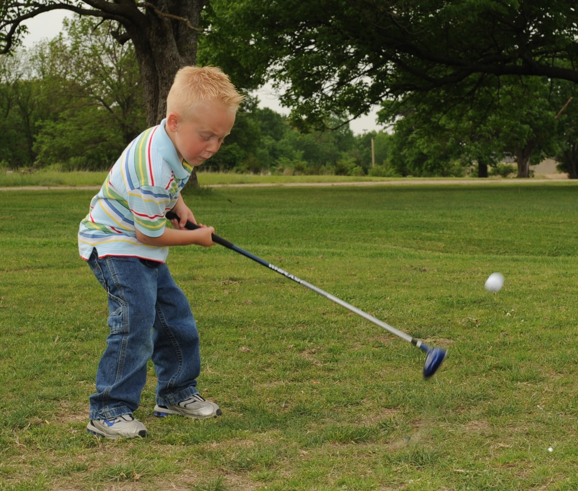 WHITEMAN AIR FORCE BASE, Mo. - Holden, a local youth, sends a golf ball flying down the Royal Oaks Golf Course driving range May 13. Holden participated in youth golf classes held by the 509th Force Support Squadron. (U.S. Air Force photo/Staff Sgt. Charles Larkin)  
