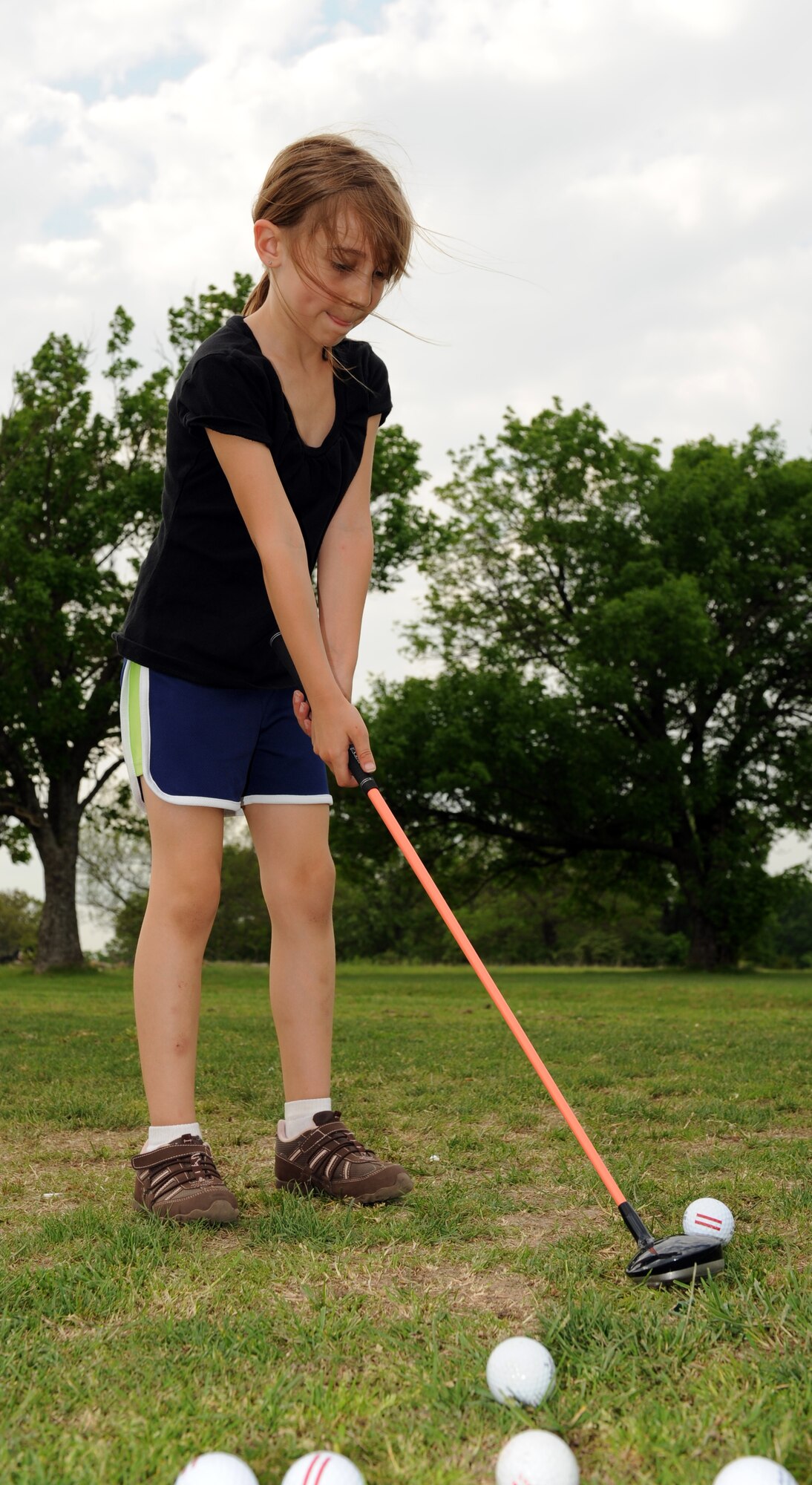 WHITEMAN AIR FORCE BASE, Mo. - Kayley, a local youth, practices hitting golf balls at the Royal Oaks Golf Course driving range May 13. Kayley participated in youth golf classes held by the 509th Force Support Squadron. (U.S. Air Force photo/Staff Sgt. Charles Larkin)  