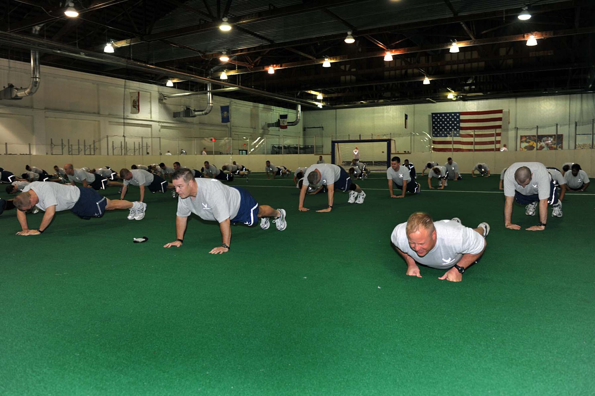 OFFUTT AIR FORCE BASE, Neb. -- Members of the Fightin' Fifty-Fifth perform push-ups during physical training at the Offutt Field House May 15. Physical training helps prepare personnel for their annual PT test and helps ensure they're "fit to fight." U.S. Air Force photo by Charles Haymond