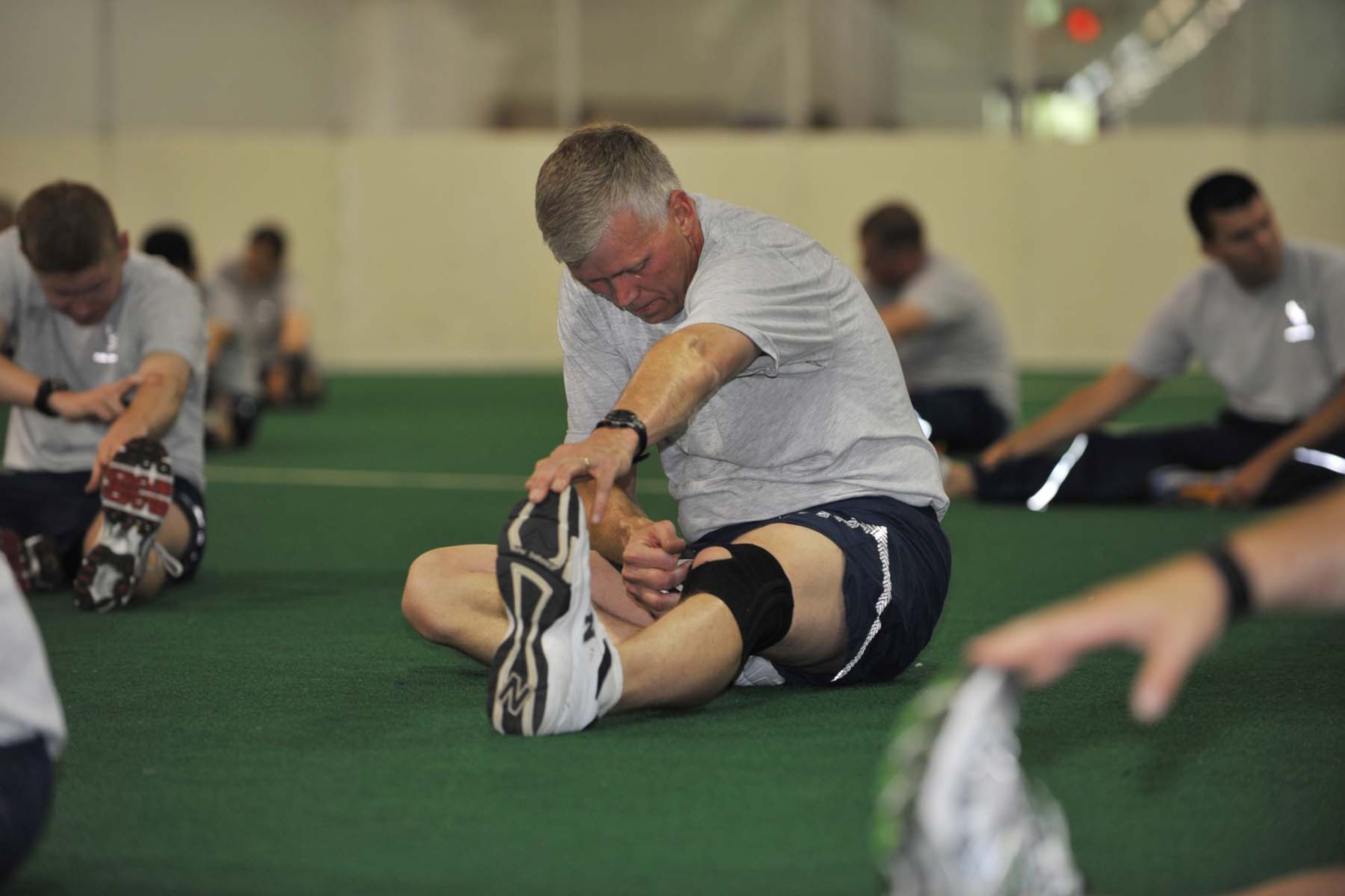 OFFUTT AIR FORCE BASE, Neb. -- Members of the Fightin' Fifty-Fifth stretch after physical training at the Offutt Field House May 15. Physical training helps prepare personnel for their annual PT test and helps ensure they're "fit to fight." U.S. Air Force photo by Charles Haymond