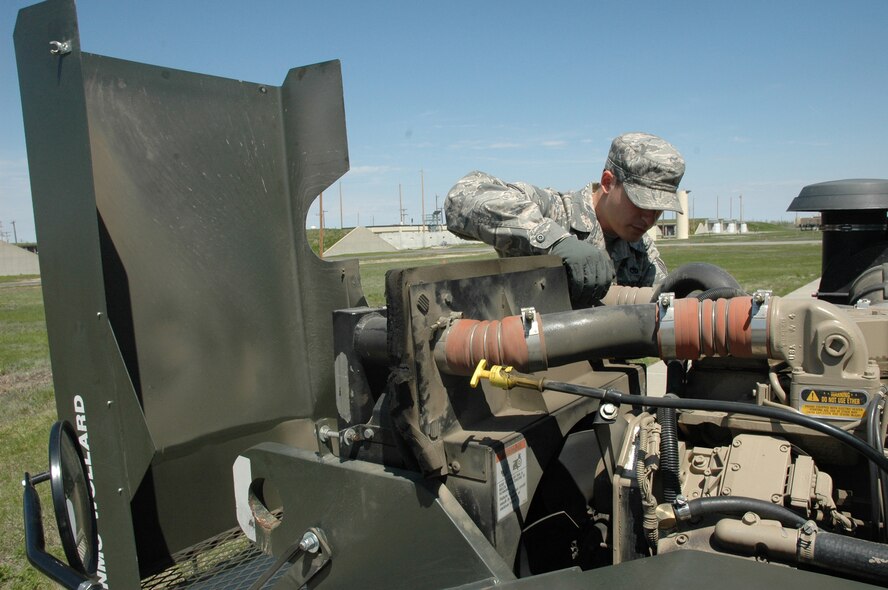 MINOT AIR FORCE BASE, N.D. – Staff Sgt. Steven Adams, 5th Munitions Squadron, performs a vehicle inspection on a tug at the Weapons Storage Area during a Nuclear Surety Inspection here May 19. An NSI is designed to evaluate a unit's readiness to execute nuclear operations. Areas to be evaluated during the NSI include operations, maintenance, security, and support activities needed to ensure the wing performs its mission in a safe, secure and reliable manner. This no-notice inspection is expected to conclude May 22. (U.S. Air Force photo by Senior Airman Wesley Wright)