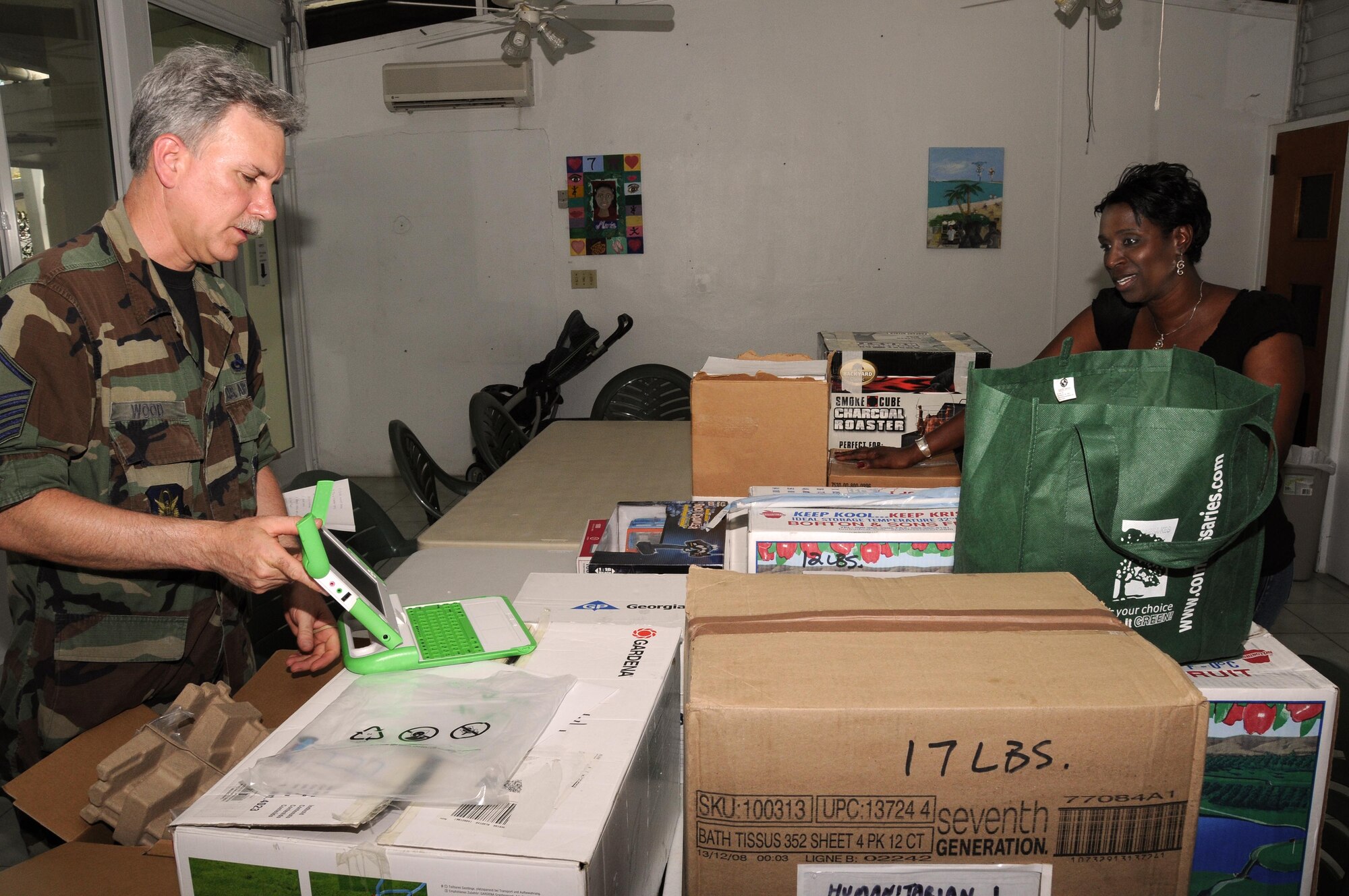 Master Sgt. Paul Wood, 403rd Maintenance Squadron, presents a laptop to Junia Straker, chief executive officer of Lutheran Social Services, at the Queen Louise Home in St. Croix, U.S. Virgin Islands.  Members from the 403rd Wing collect donations throughout the year for the home and fly them down on a space-available basis when the 53rd Weather Reconnaissance Squadron flies to their forward operating location in St. Croix during hurricane season.  