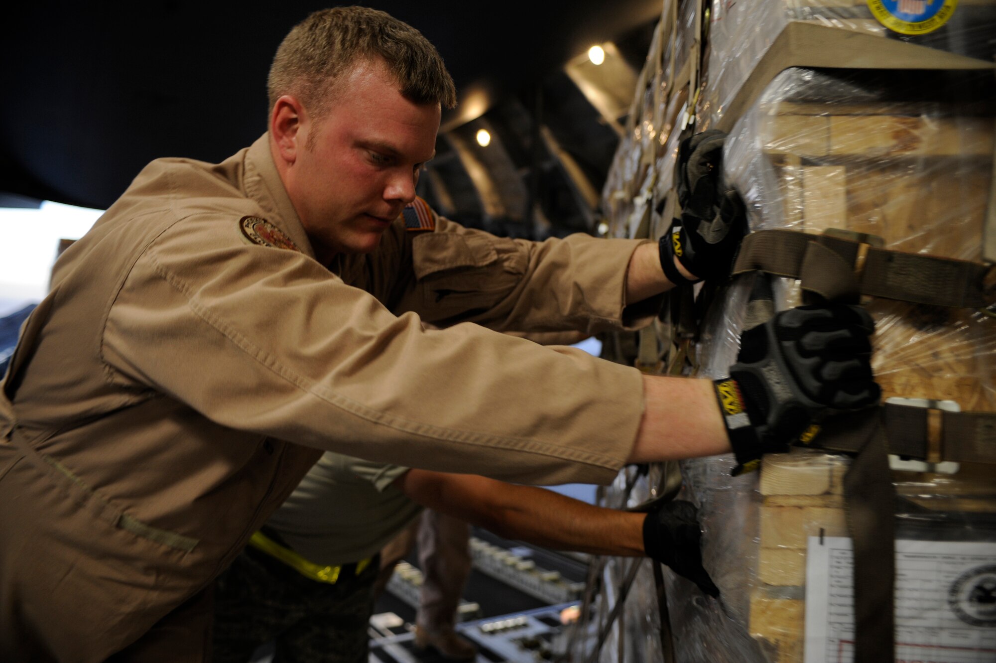 U.S. Air Force Tech. Sgt. Matt Pease, a Raven assigned to the 816th Espeditionary Airlift Squadron, loads a pallet containing humanitarian relief supplies destined for Pakistan into the cargo bay of a C-17 Globemaster III May 20, 2009, at an undisclosed location in Southwest Asia. Sergeant Pease is deployed from the 437th Security Forces Squadron, Charleston Air Force Base, S.C. (U.S. Air Force photo by Staff Sgt. Shawn Weismiller)