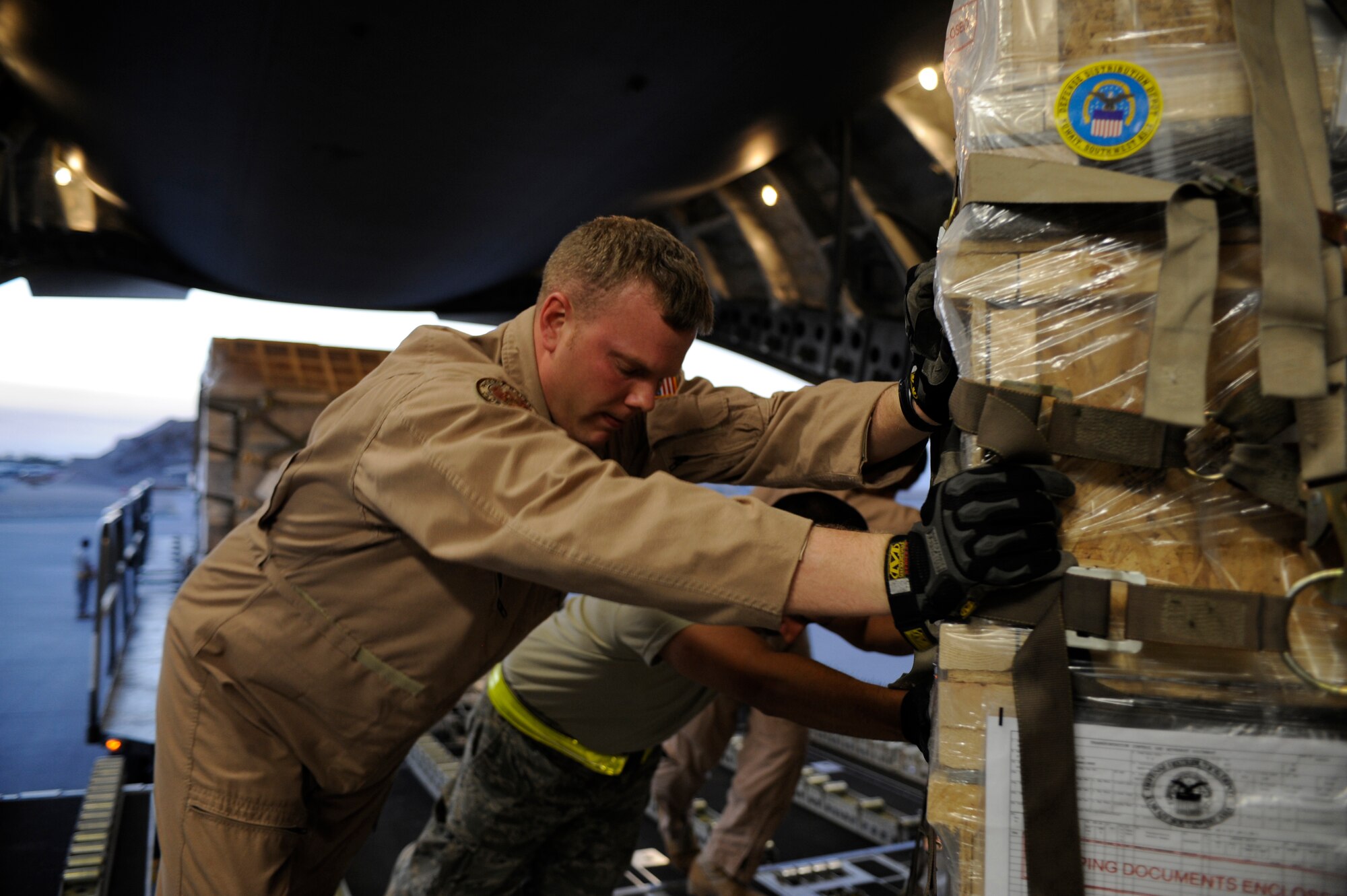 U.S. Air Force Tech. Sgt. Matt Pease, a Raven assigned to the 816th Expeditionary Airlift Squadron, loads a pallet containing humanitarian relief supplies destined for Pakistan into the cargo bay of a C-17 Globemaster III May 20, 2009, at an undisclosed location in Southwest Asia. Sergeant Pease is deployed from the 437th Security Forces Squadron, Charleston Air Force Base, S.C. (U.S. Air Force photo by Staff Sgt. Shawn Weismiller)