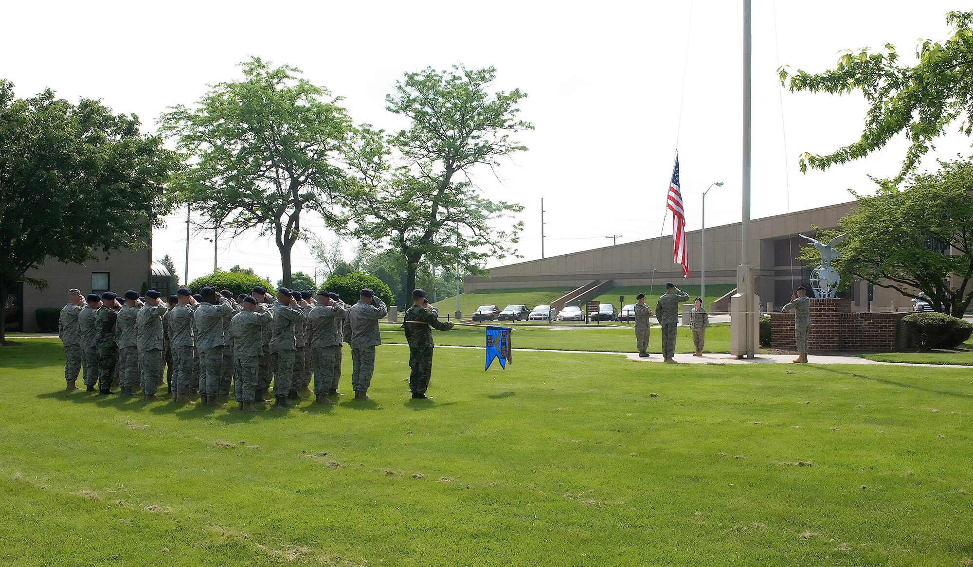 Members of the 436th Security Forces Squadron stand in formation and render honors as the flag is lowered during a retreat ceremony at Dover Air Force Base May 15. The 436th SFS Airmen performed retreat to end National Police Week, which is a time to honor those in the law enforcement profession who have made the ultimate sacrifice. (U.S. Air Force photo/Tom Randle)