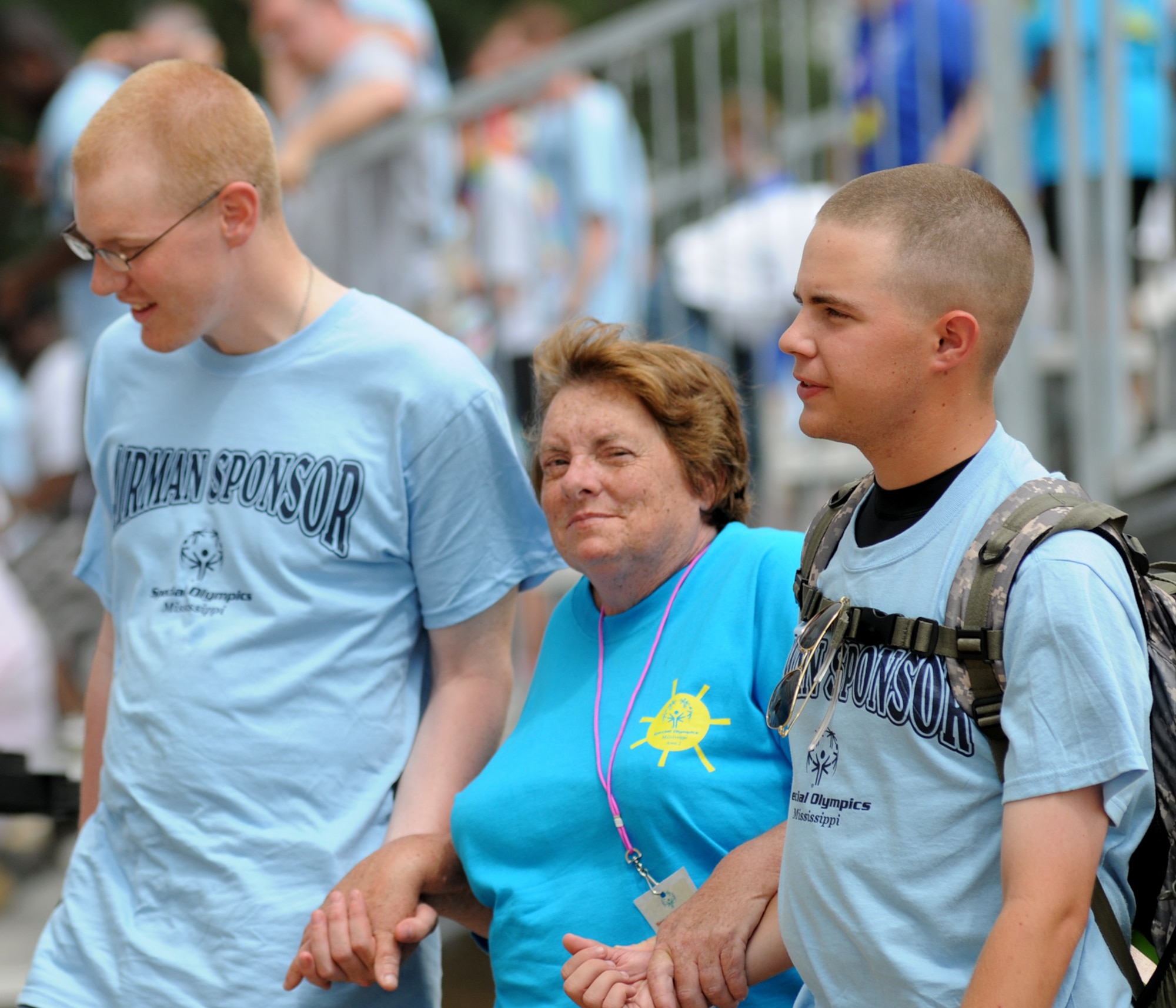 Airmen Basic Blake Schneider, left, and Jared Carter, 338th TRS students, escort Area 2 athlete Earlene Smith to safety when lightning was reported near Keesler over the weekend.  (U.S. Air Force photo by Kemberly Groue)