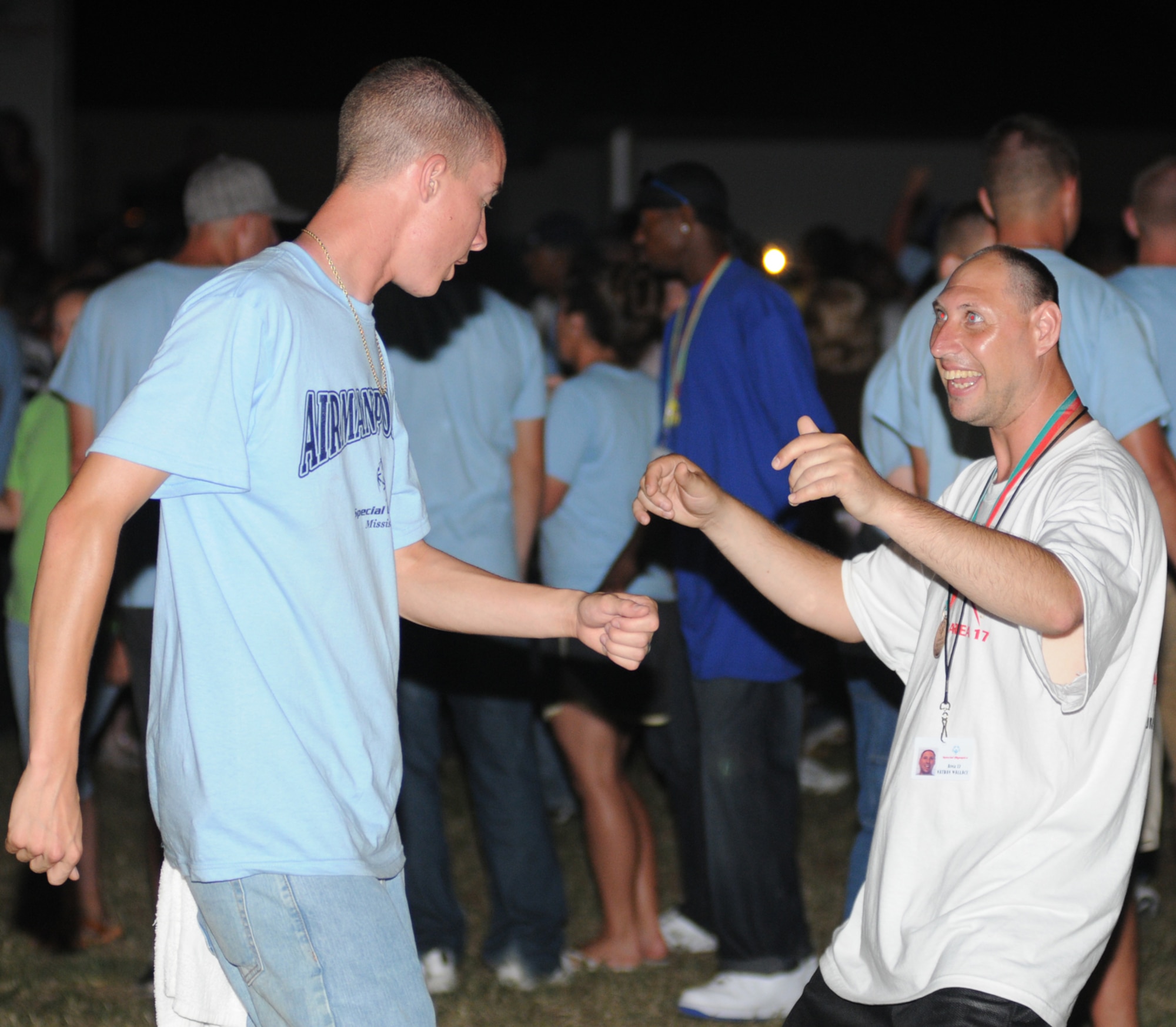 Airman Johnny Sears, “breaks it down” with Area 17 athlete Nathan Wallace at the victory dance on the parade grounds in the Triangle after Saturday’s closing ceremonies. Airman Sears, 332nd TRS, was Mr. Wallace’s sponsor.