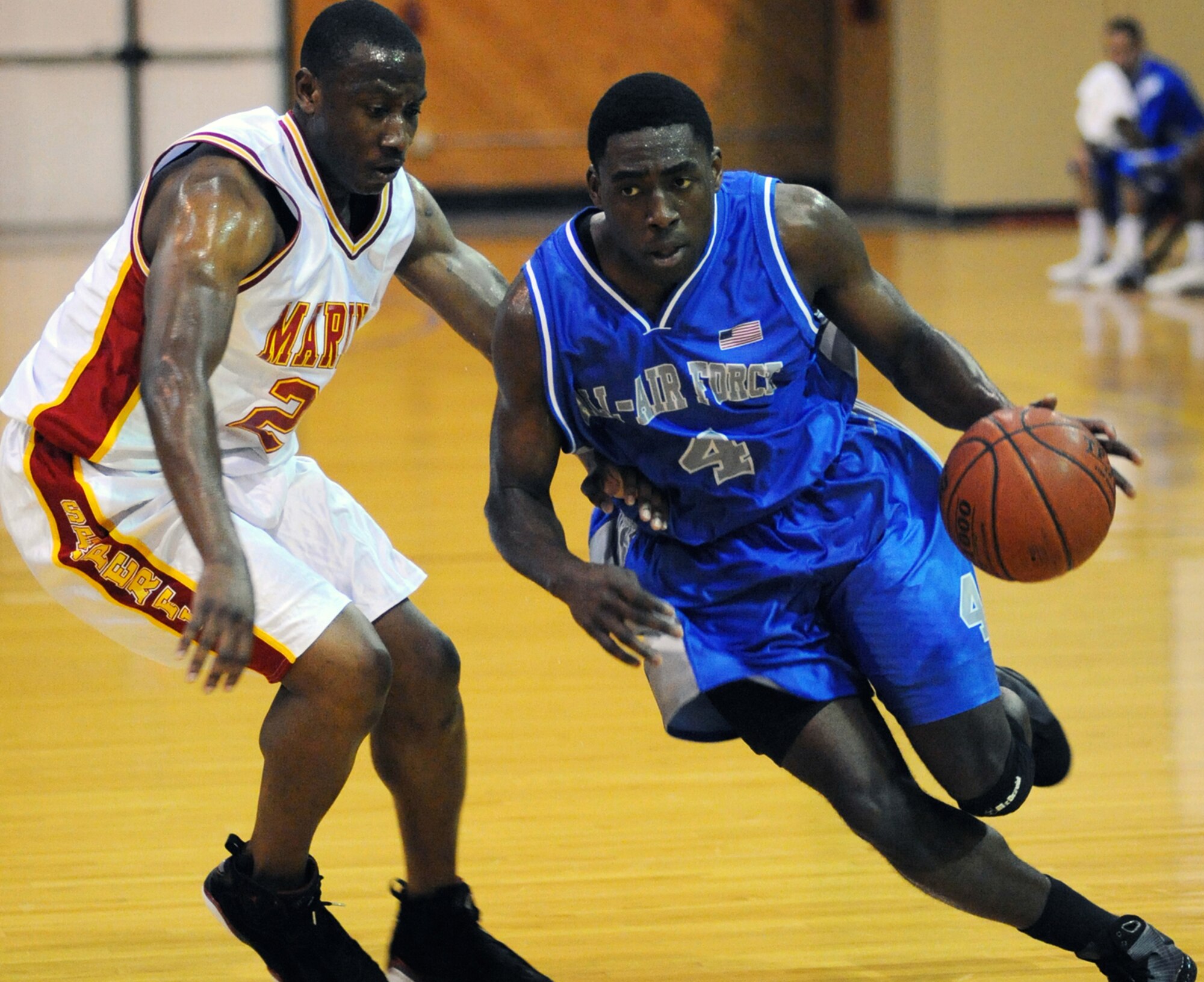 Nwaelele, right, dribbles the ball past a Marine defender during Saturday’s gold medal game.  The Air Force took the gold with a 69-65 win.  (U.S. Air Force photo by Petty Officer 1st Class John Collins) 
